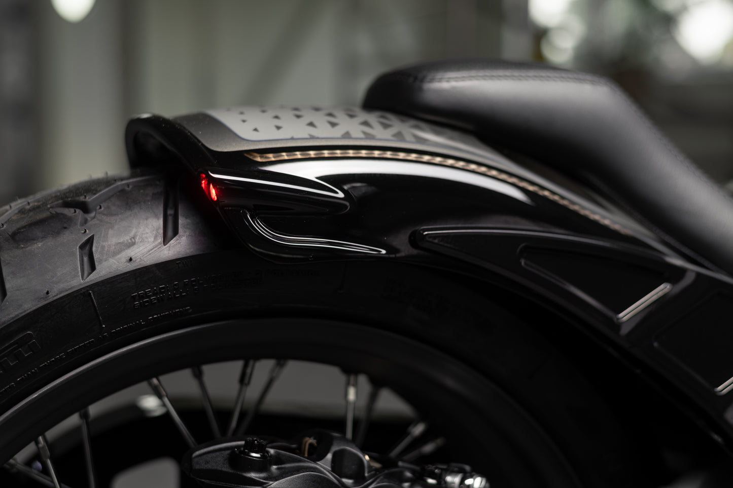 Zoomed Harley Davidson motorcycle with Killer Custom "Rodstr" rear fender blurry background