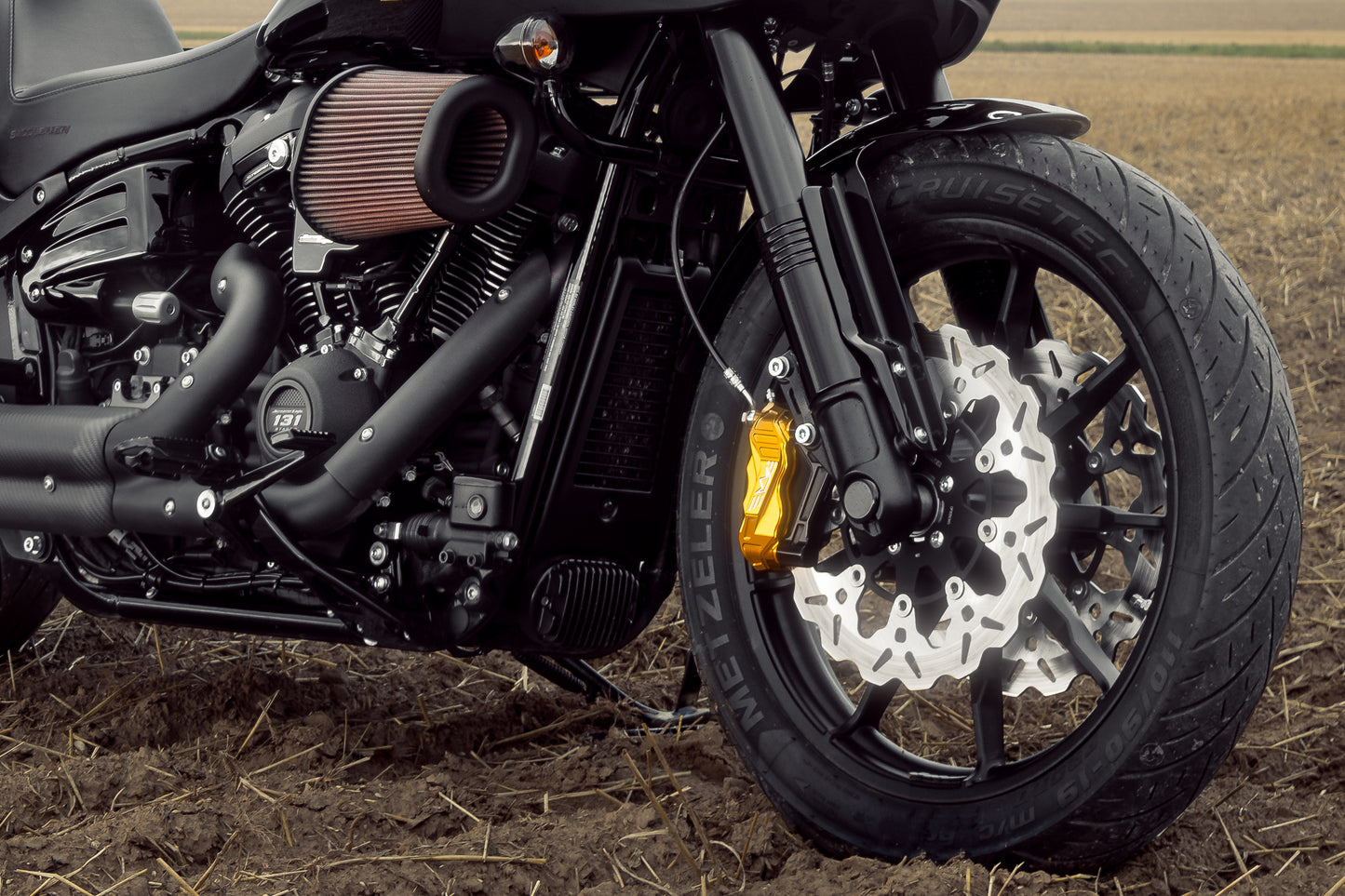 Harley Davidson motorcycle with Killer Custom fat bob and low ride lower fork covers in a nature environment