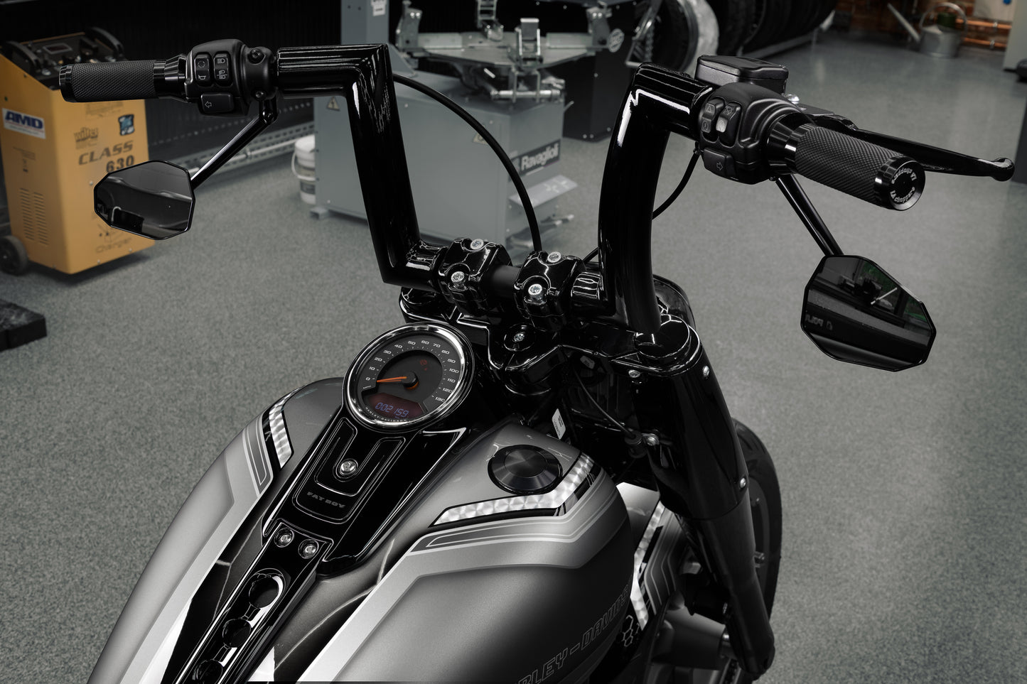 Harley Davidson motorcycle with Killer Custom fork end caps in a modern bike shop with some equipment in the background