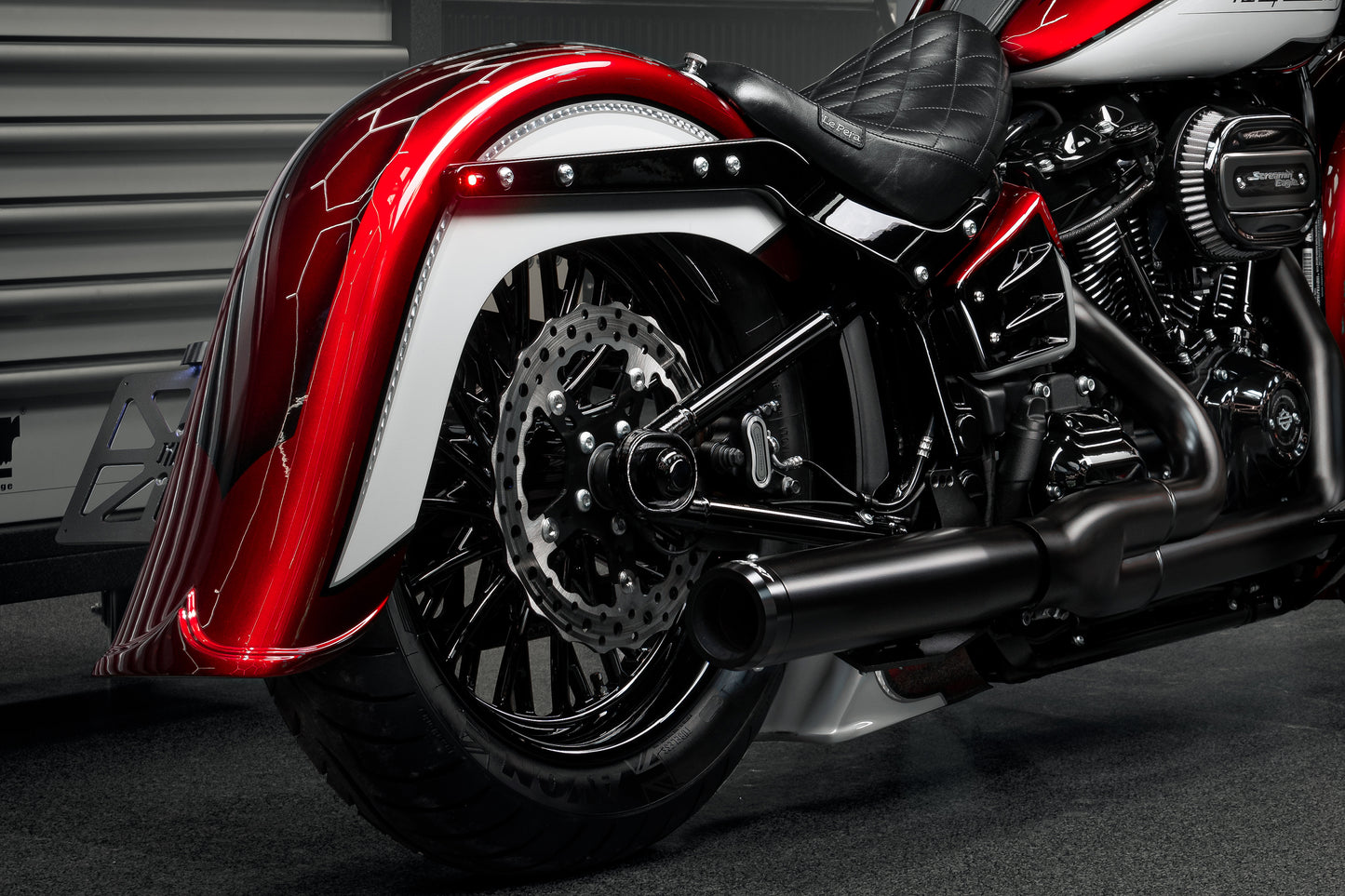Harley Davidson motorcycle with Killer Custom micro extreme atto dark running/brake/turn signals from the rear in an industrial environment