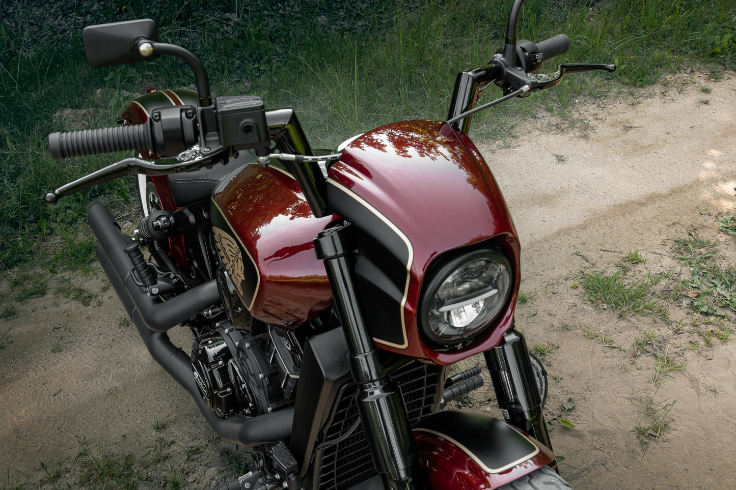Harley Davidson motorcycle with Killer Custom "Tomahawk" series headlight fairing from above in the forest