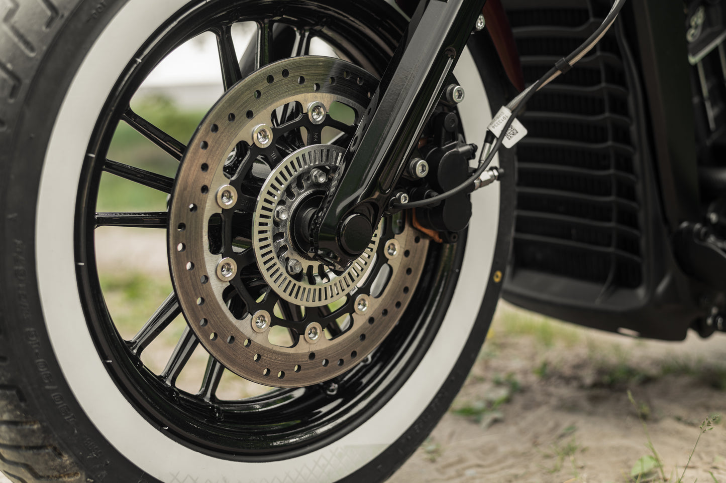 Zoomed Harley Davidson motorcycle with Killer Custom  front axle cover caps set blurry background