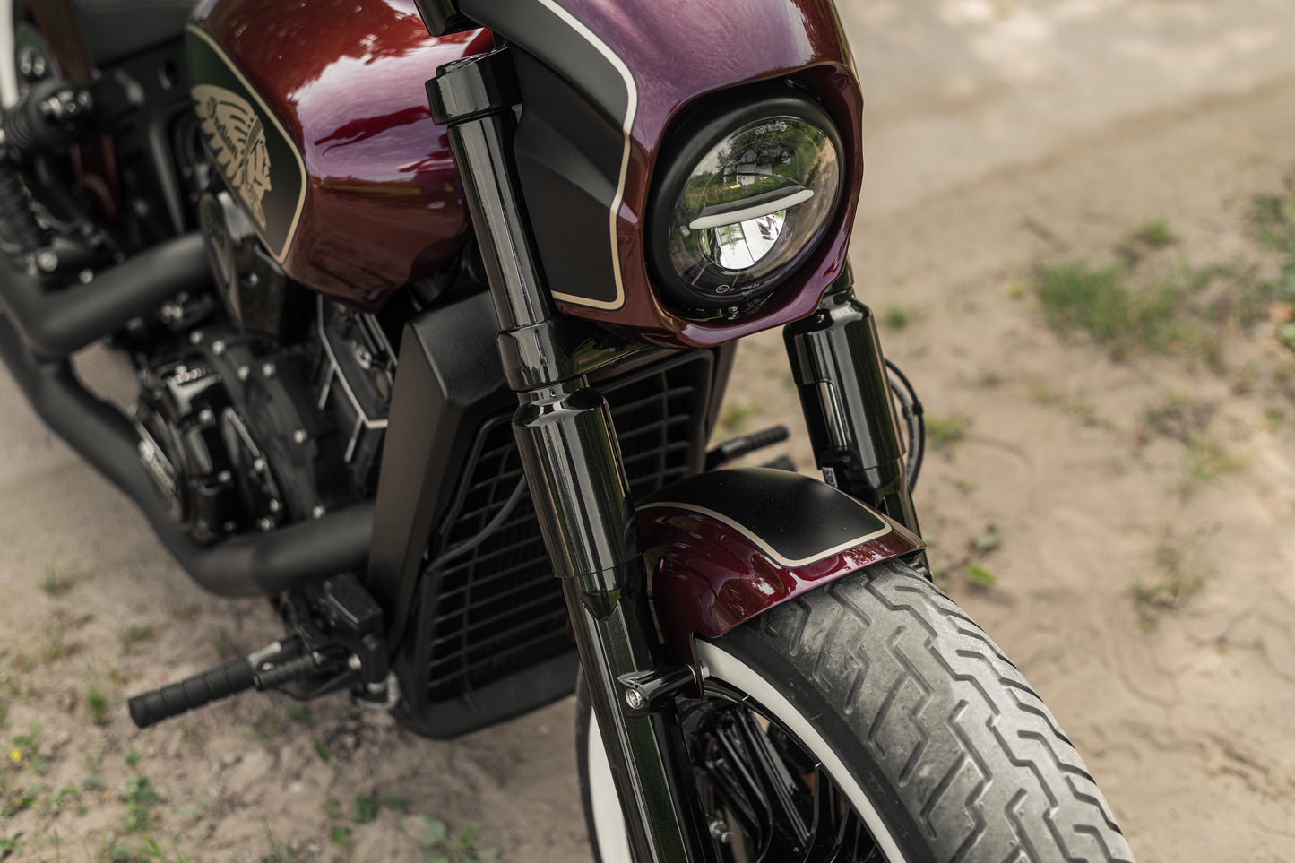 Zoomed Harley Davidson motorcycle with Killer Custom "Tomahawk" full fork covers set from the front on a roadside