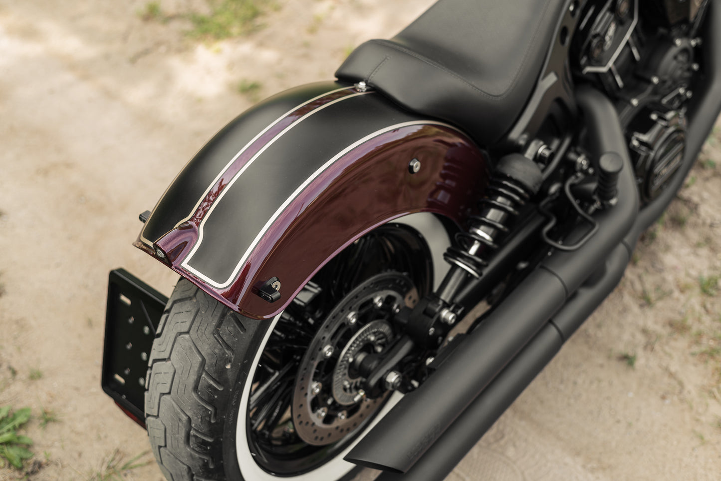 Harley Davidson motorcycle with Killer Custom "Apache" rear fender from above on the forest ruts