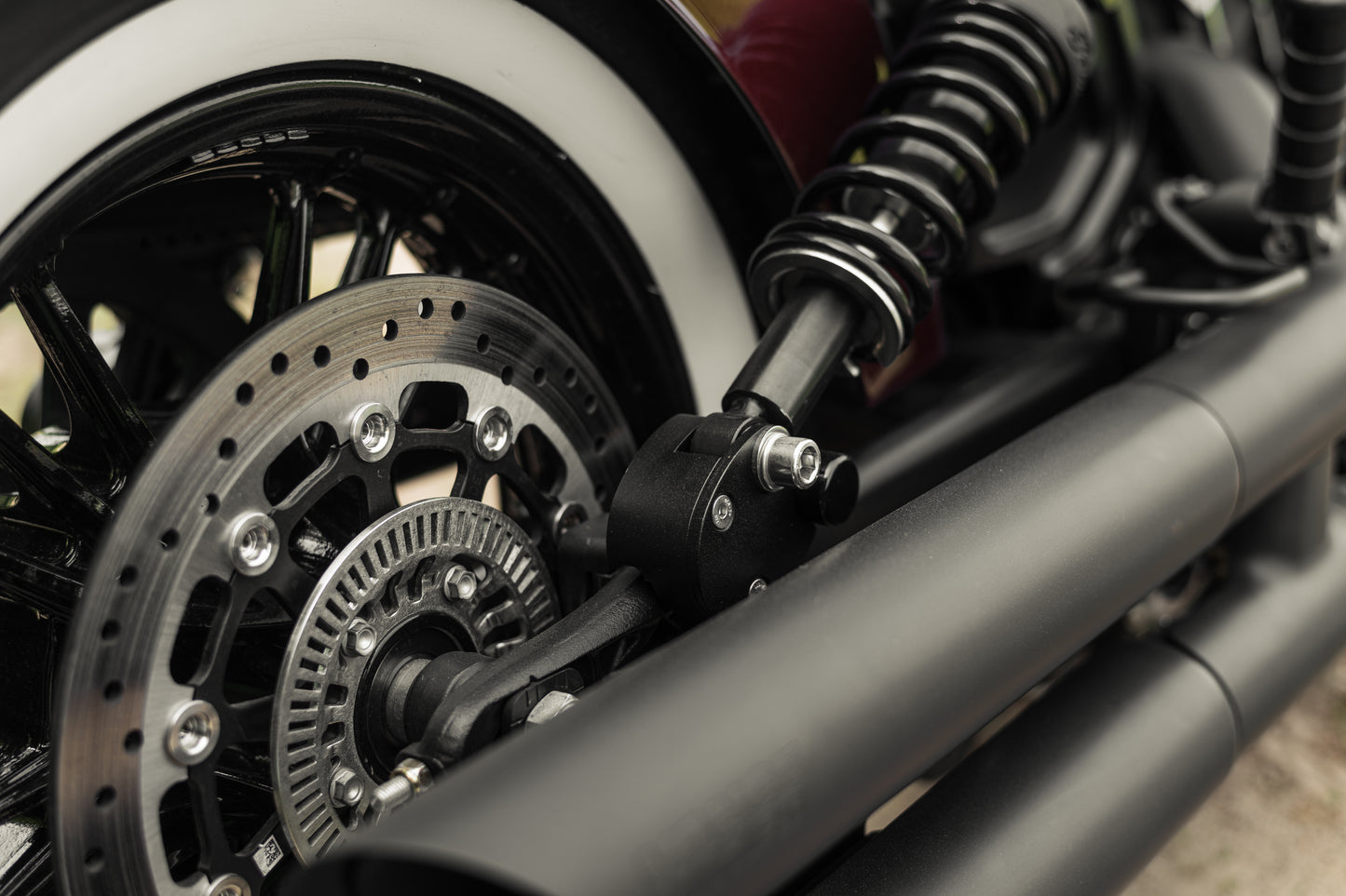 Zoomed Harley Davidson motorcycle with Killer Custom rear shock lowering kit from the side