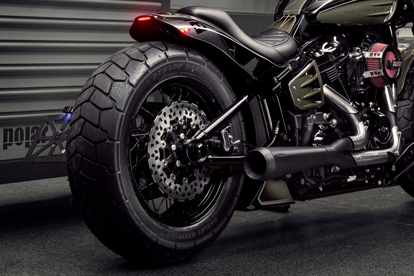 Harley Davidson motorcycle with Killer Custom micro extreme atto dark running/brake/turn signals from the rear in an industrial environment