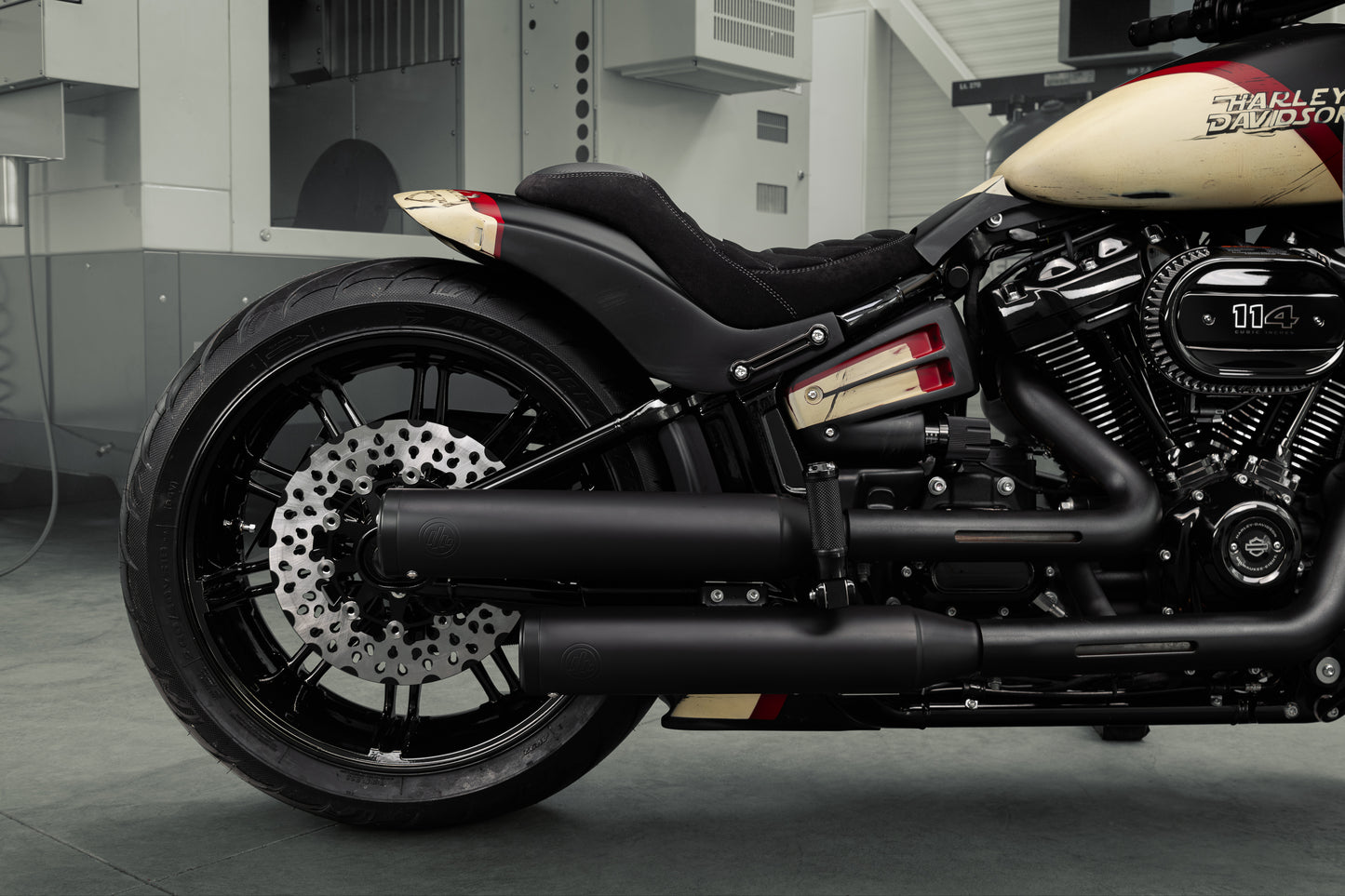 Harley Davidson motorcycle with Killer Custom "Avenger" rear fender kit from the side in a modern bike shop