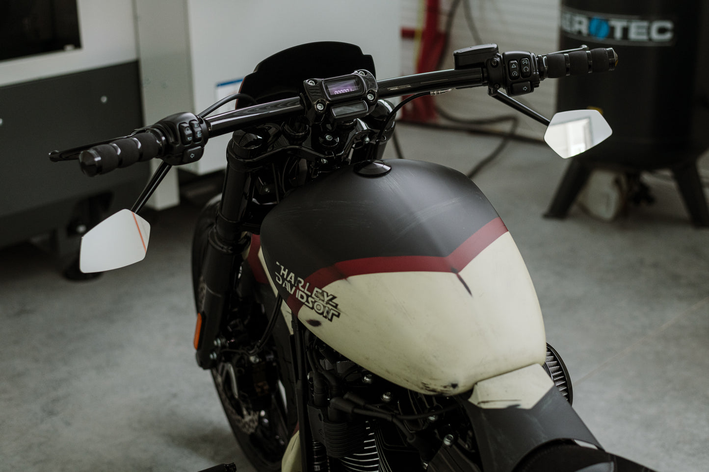 Harley Davidson motorcycle with Killer Custom fork end caps from the rear in a modern bike shop