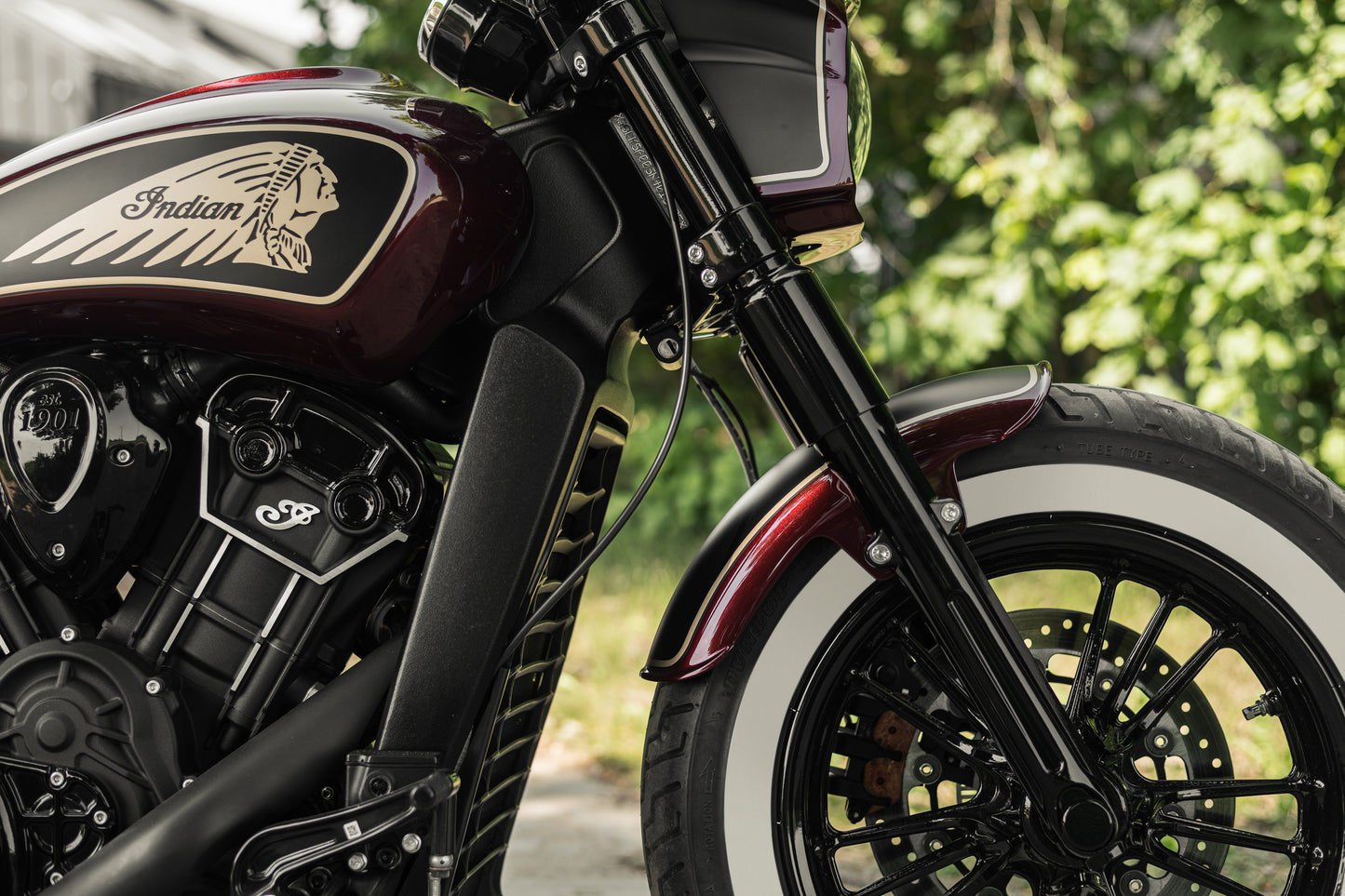 Harley Davidson motorcycle with Killer Custom "Tomahawk" full fork covers set from the side green blurred background
