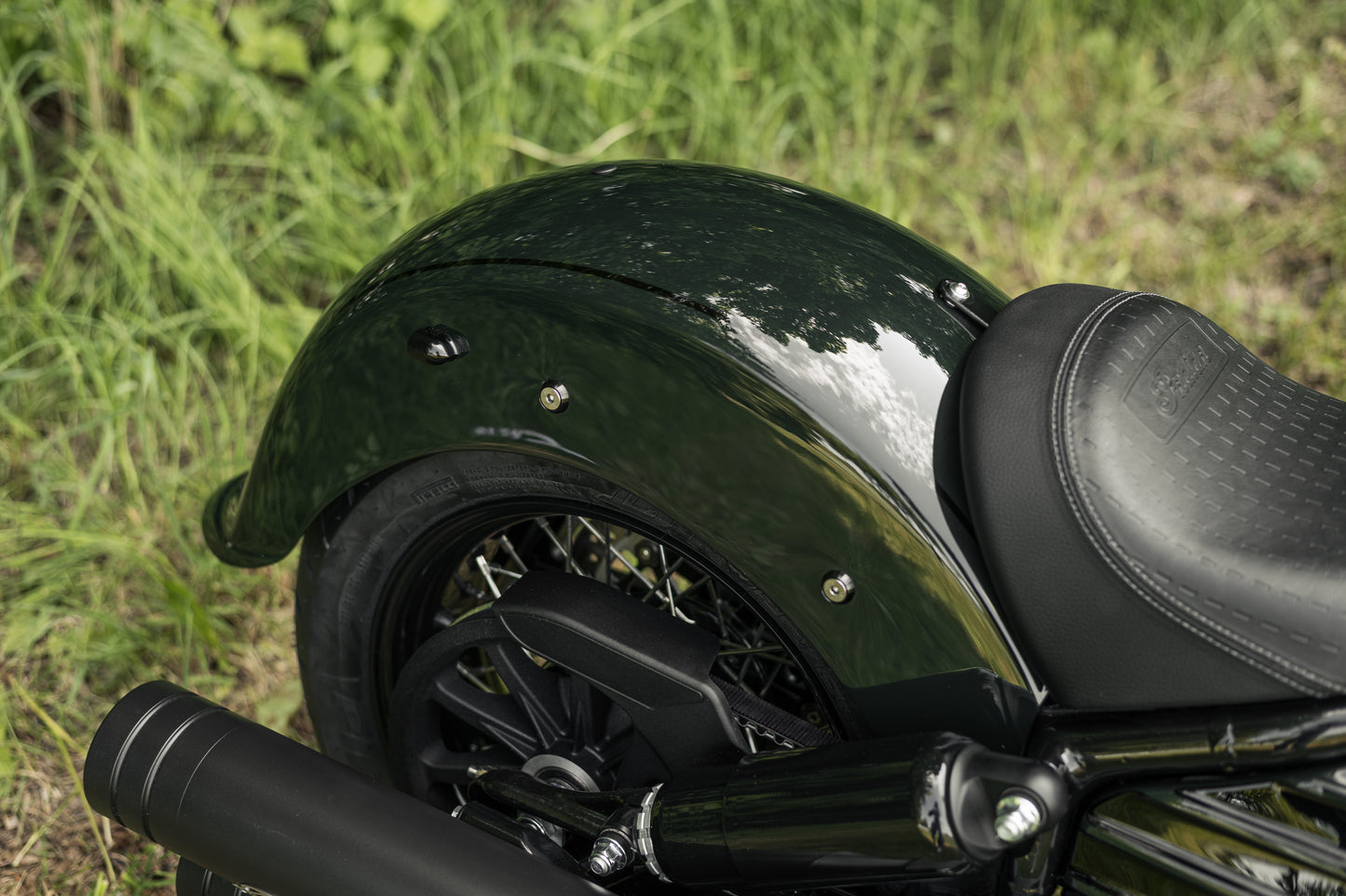 Zoomed Harley Davidson motorcycle with Killer Custom "Apache" rear fender from above on the grass