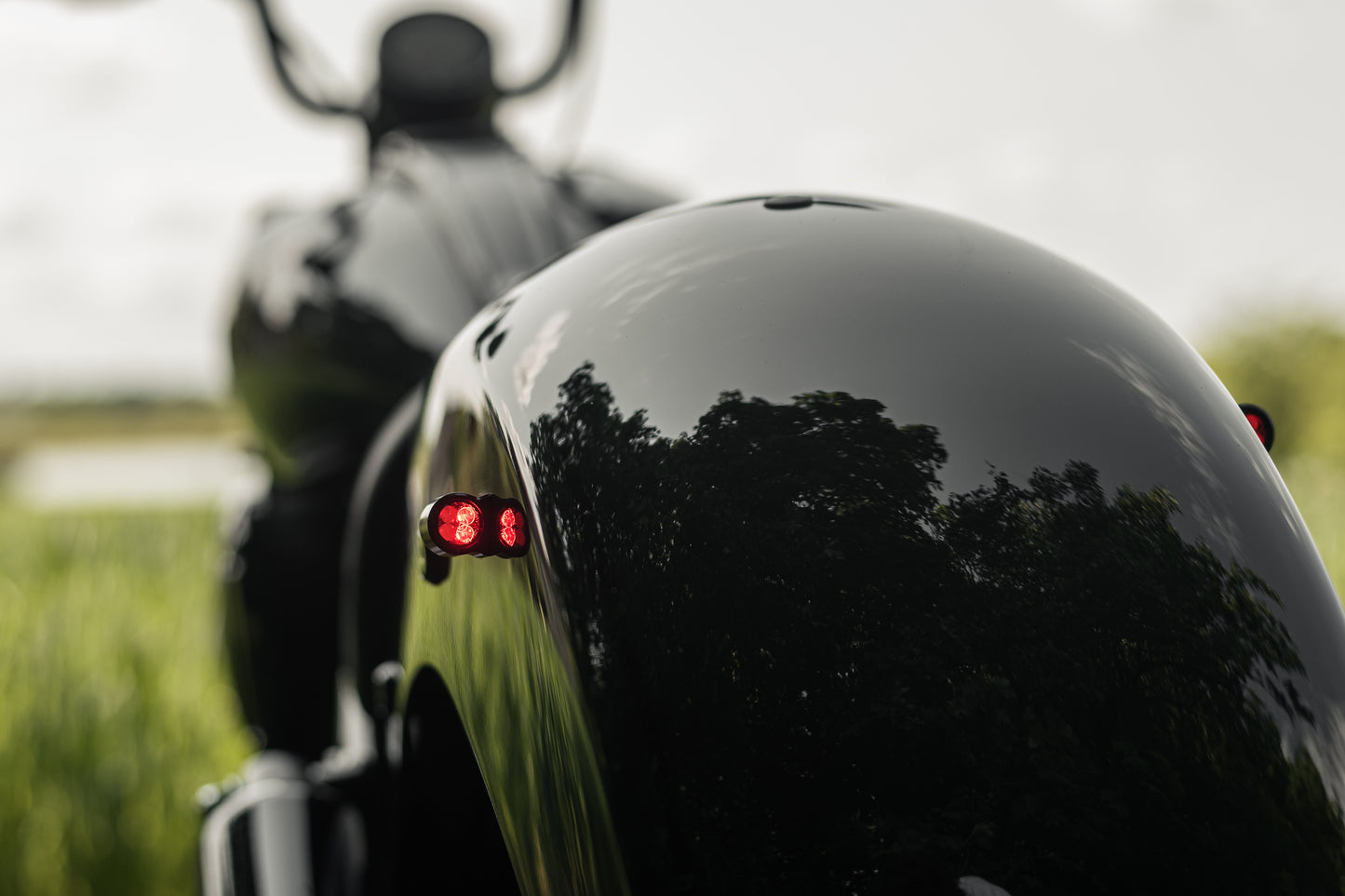 Zoomed Harley Davidson motorcycle with Killer Custom parts from the rear blurry background