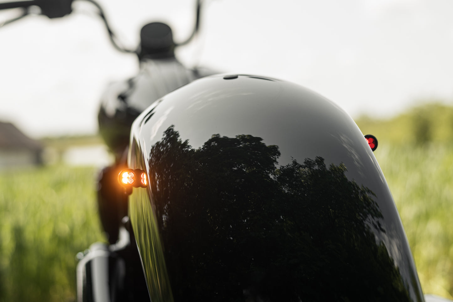 Zoomed Harley Davidson motorcycle with Killer Custom parts from the rear blurry background