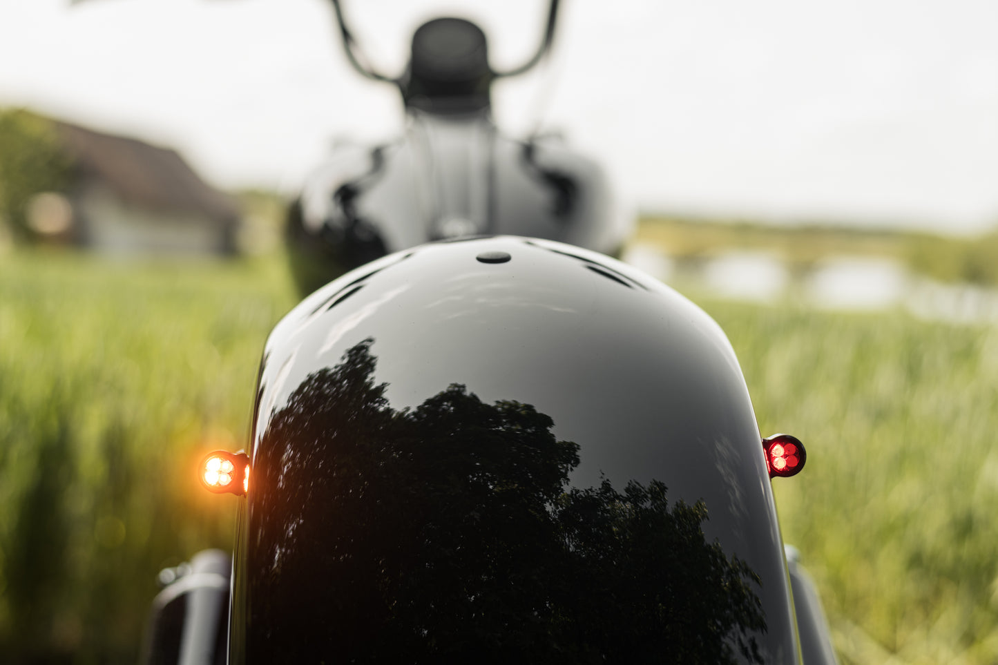 Zoomed Harley Davidson motorcycle with Killer Custom parts from the rear blurry background