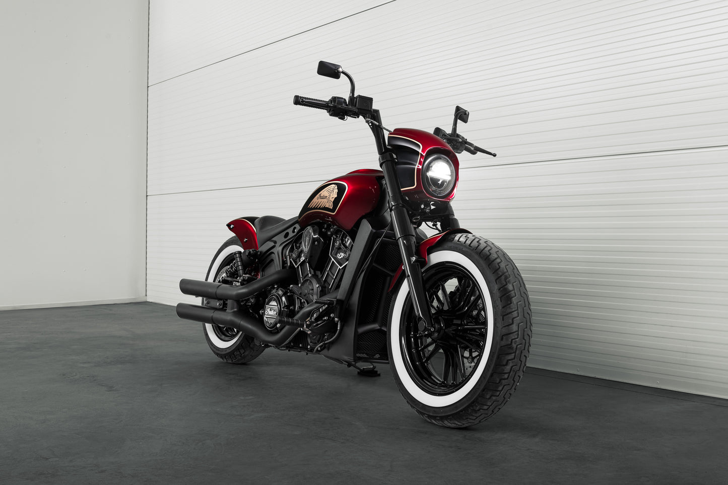 Harley Davidson motorcycle with Killer Custom "Tomahawk" series headlight fairing from the side in a modern garage