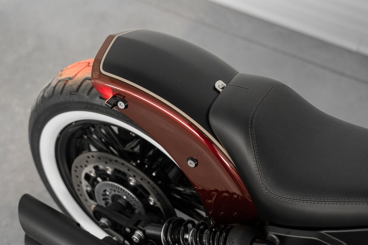 Harley Davidson motorcycle with Killer Custom "Tomahawk" rear fender from above grey background
