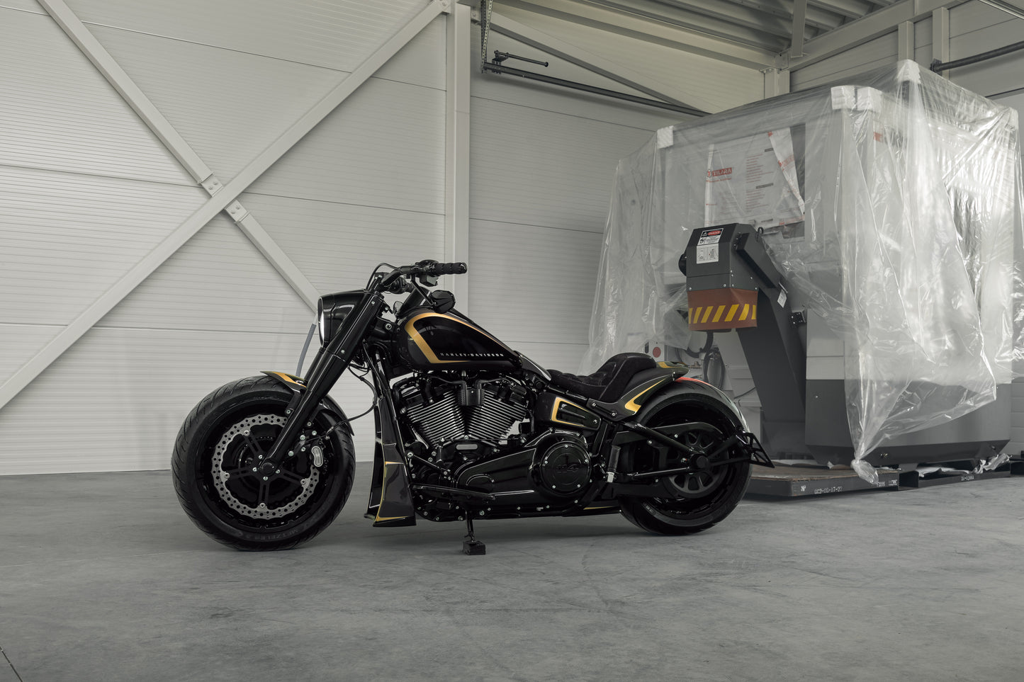 Harley Davidson motorcycle with Killer Custom parts from the side in a white spacious garage