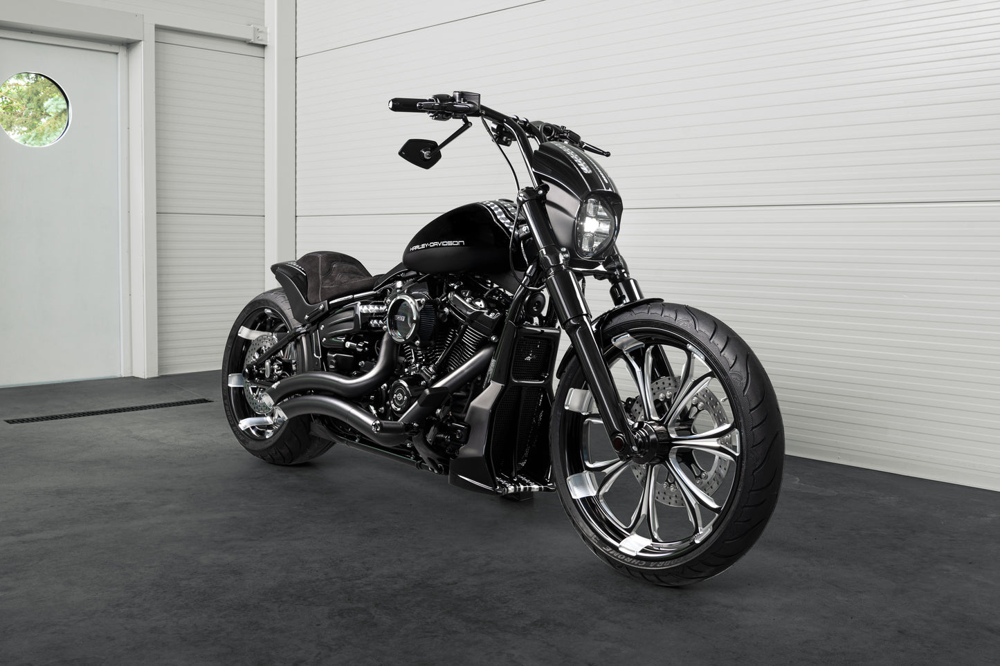 Harley Davidson motorcycle with Killer Custom "Race" mirrors from the side in a white modern garage