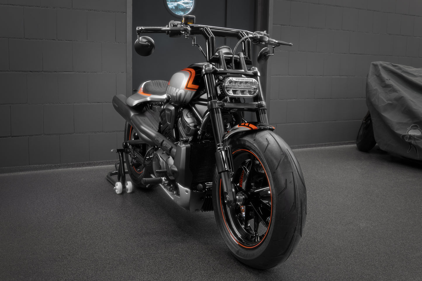 Harley Davidson motorcycle with Killer Custom "Killer Bull" t-bar from the front in a modern garage