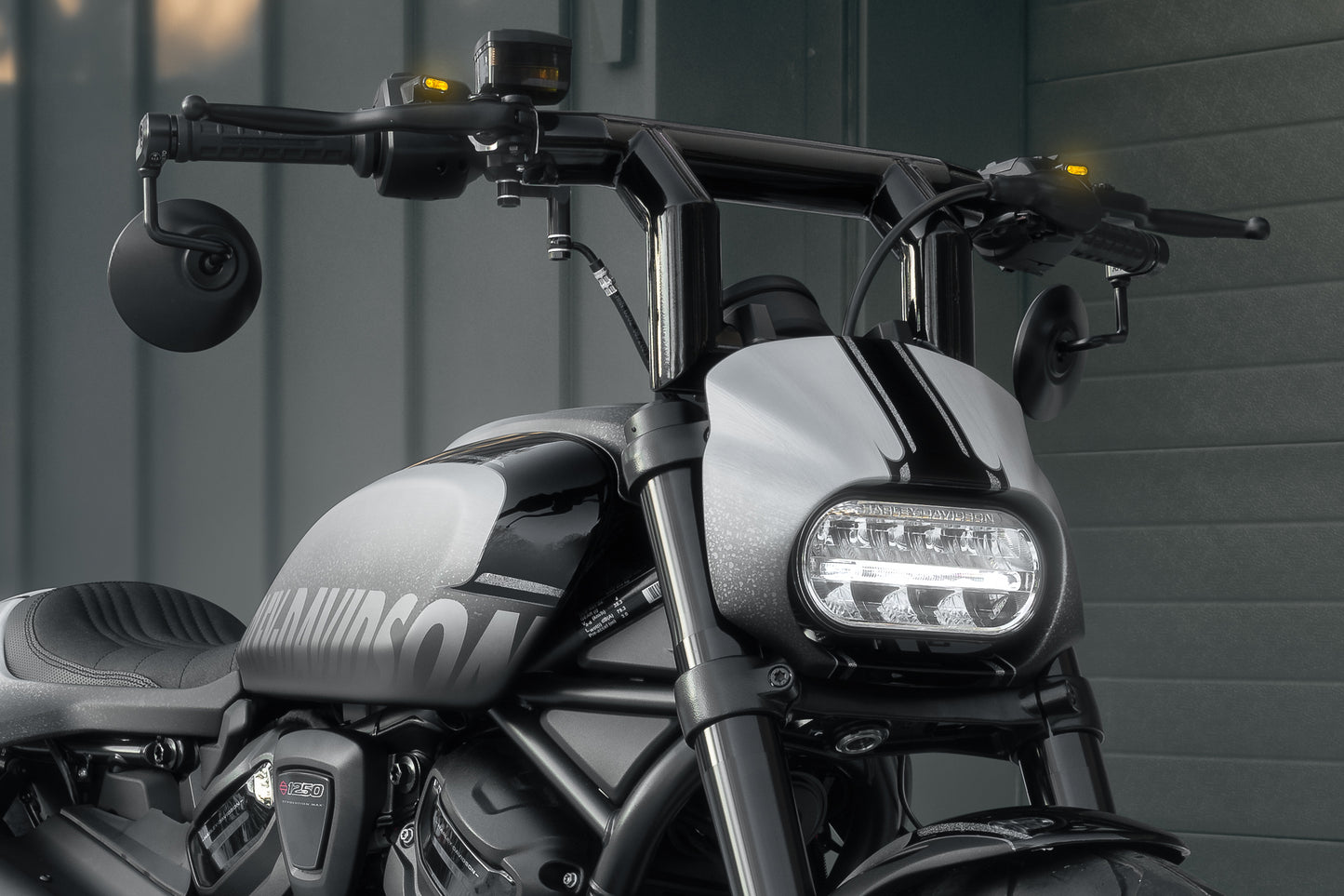 Zoomed Harley Davidson motorcycle with Killer Custom headlight fairing mask form the front grey background