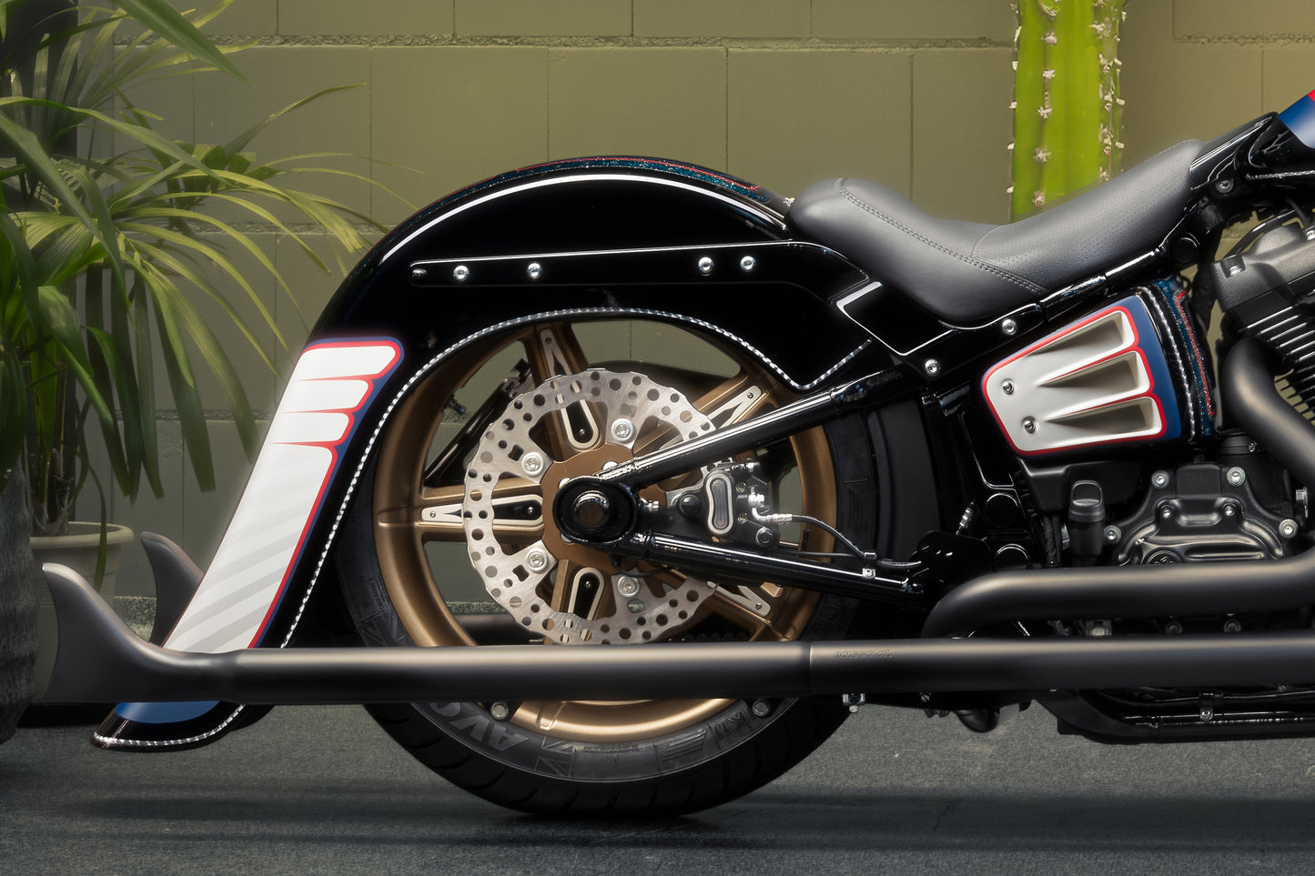 Zoomed Harley Davidson motorcycle with Killer Custom rear fender from the side in an industrial environment