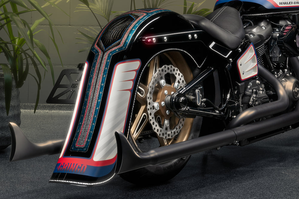 Zoomed Harley Davidson motorcycle with Killer Custom rear fender from the rear in an industrial environment