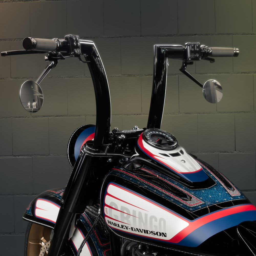 Zoomed Harley Davidson motorcycle with Killer Custom "Monarch" fat handlebars from the rear bricks background