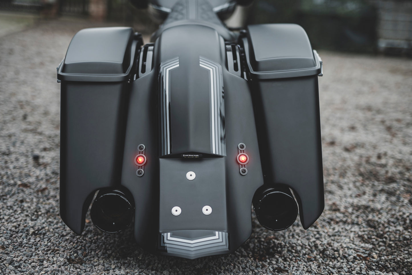 Harley Davidson motorcycle with Killer Custom running/brake/turn signals from the rear outside on a gloomy day blurry background