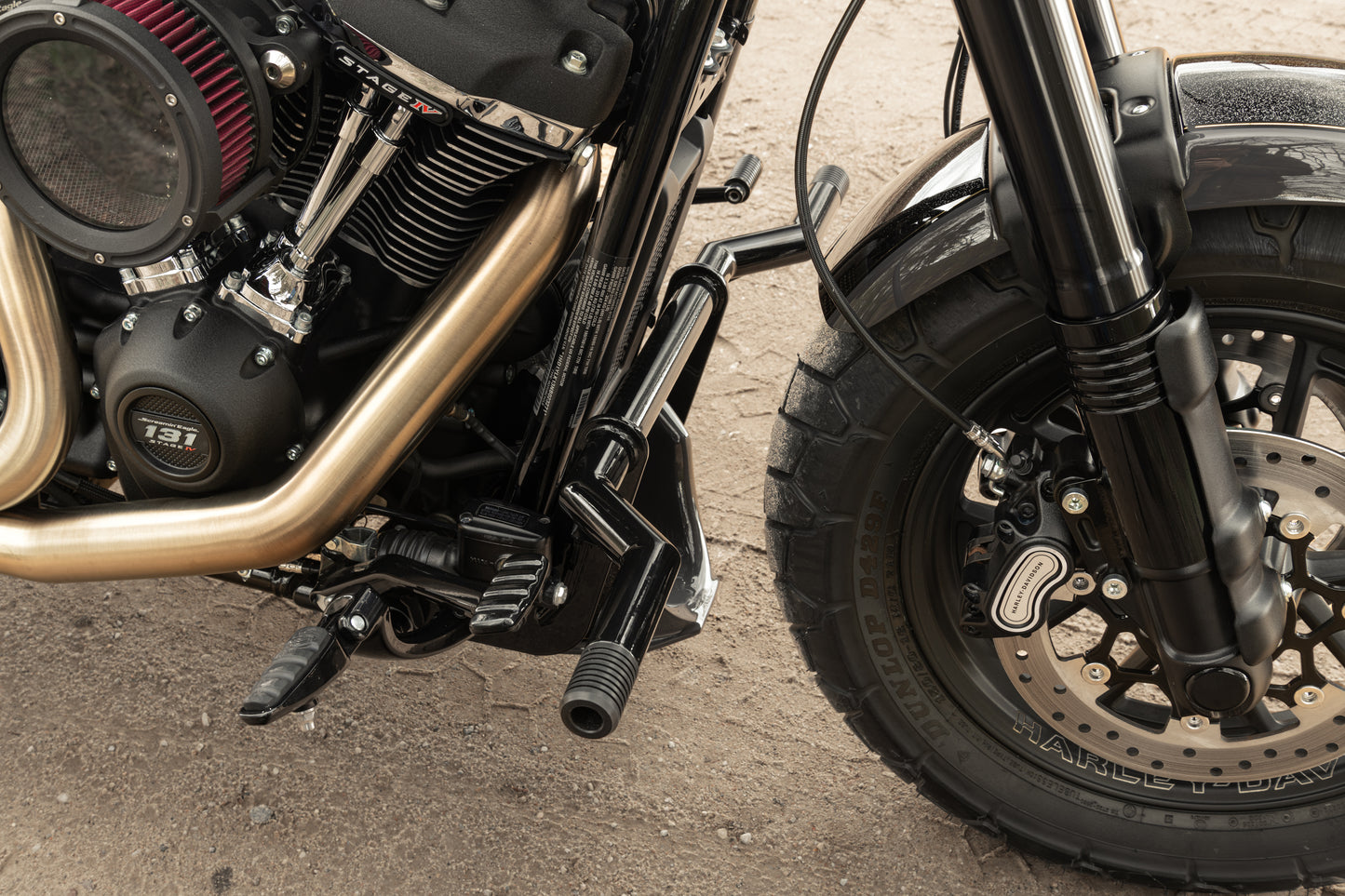 Zoomed Harley Davidson motorcycle with Killer Custom "Task Force" softail M8 crash bar on a roadside