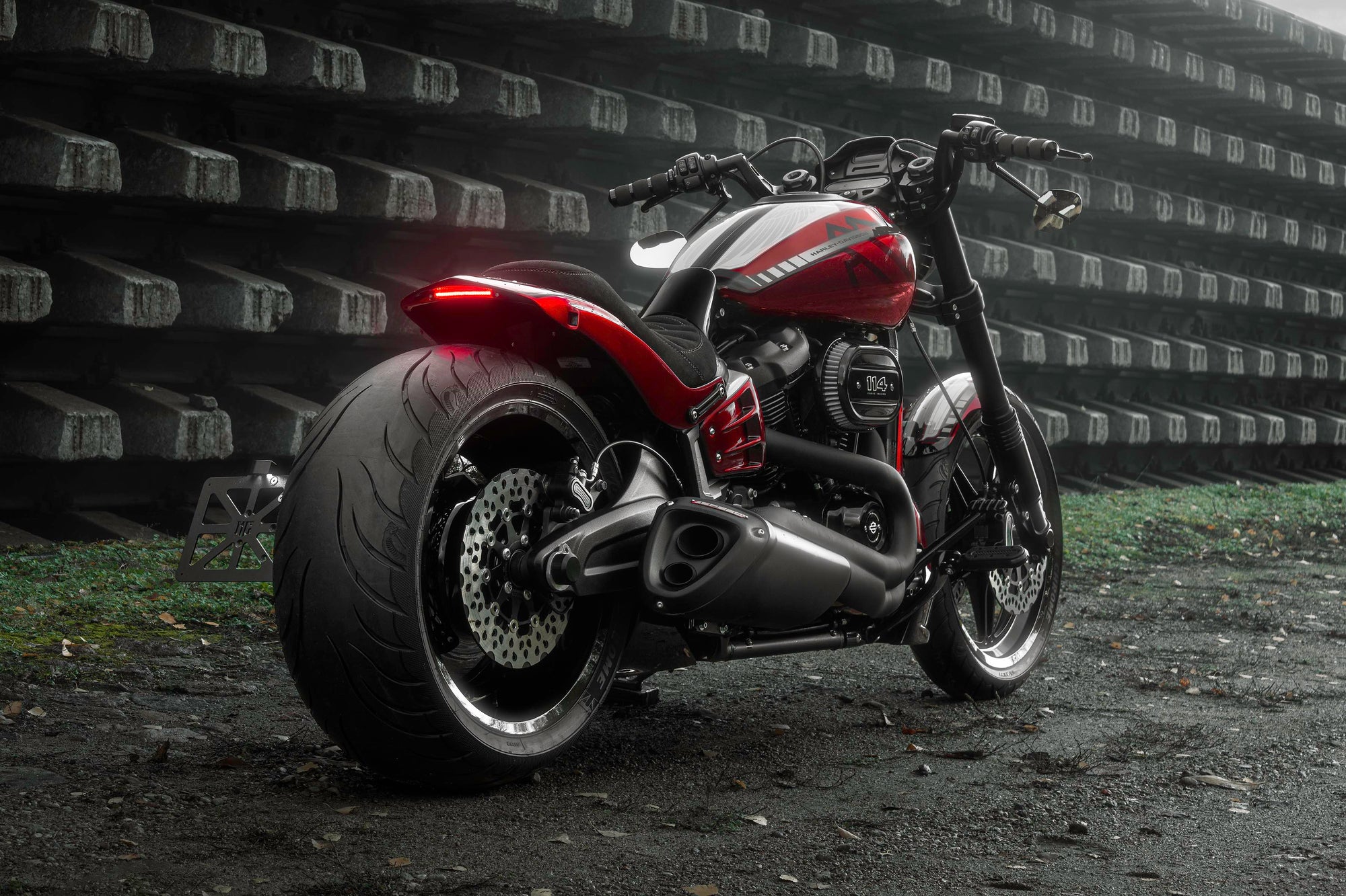 Harley Davidson motorcycle with Killer Custom parts from the rear outside on a gloomy day in an industrial environment