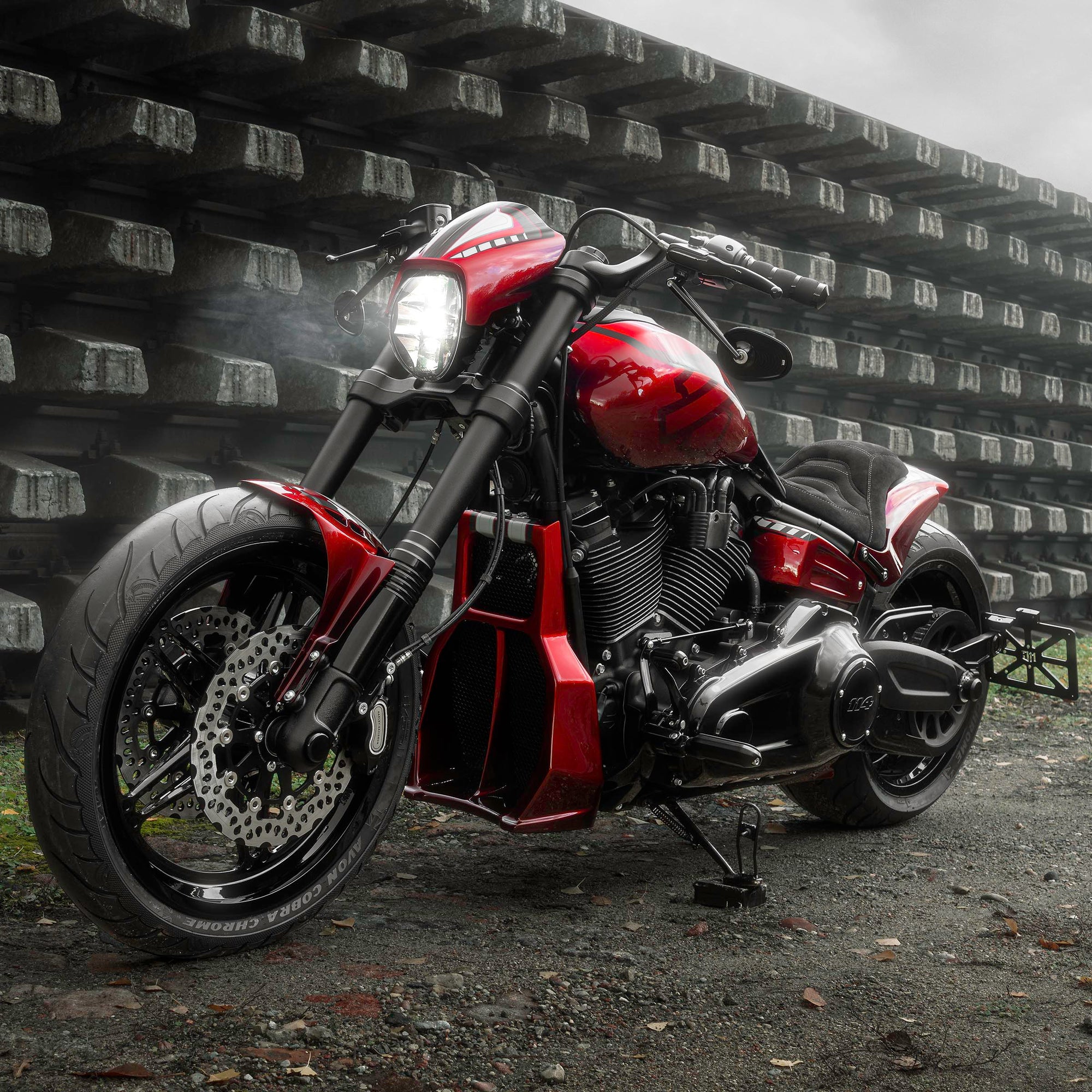 Harley Davidson motorcycle with Killer Custom parts from the side outside on a gloomy day in an industrial environment