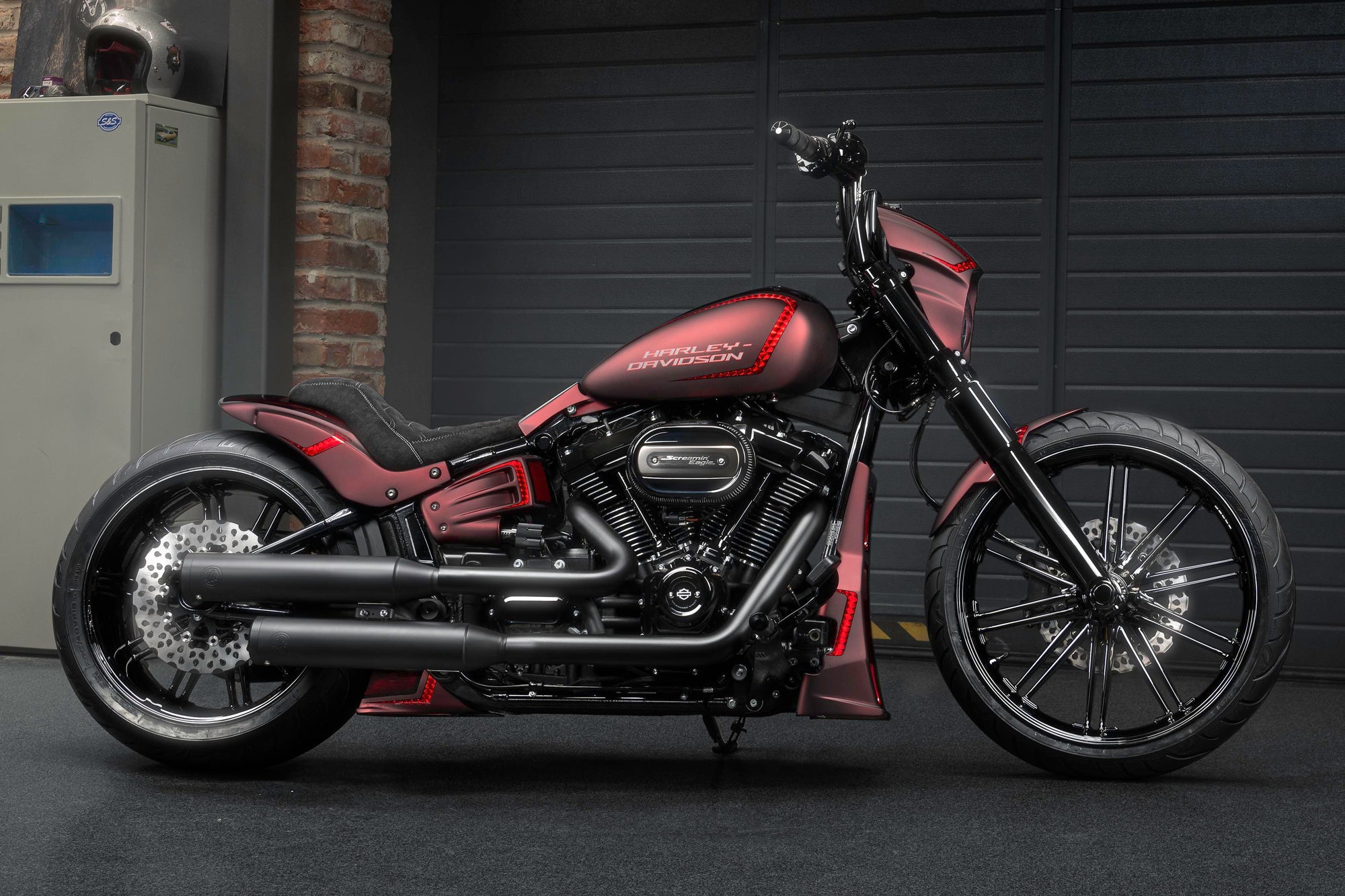Harley Davidson motorcycle with Killer Custom parts from the side in a modern garage