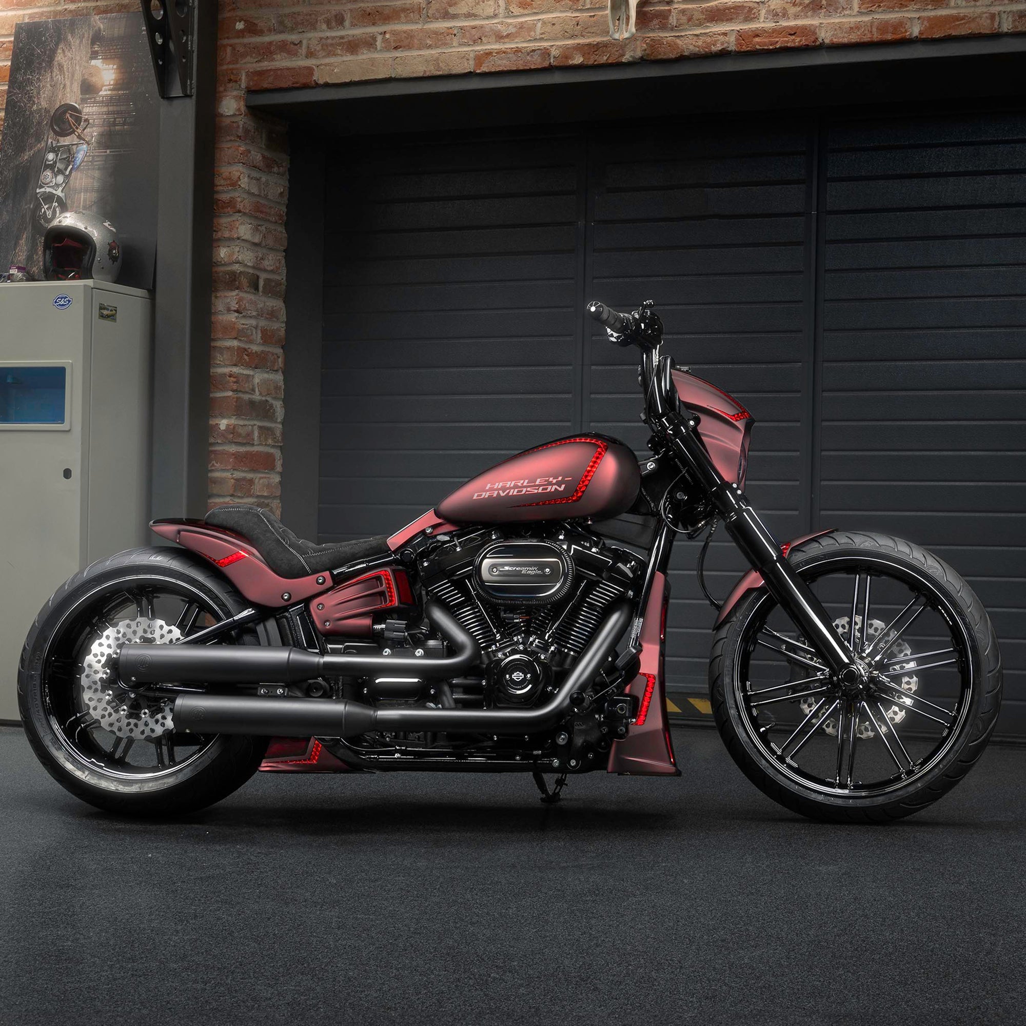 Modified Harley Davidson Breakout motorcycle with Killer Custom parts from the side in a modern garage