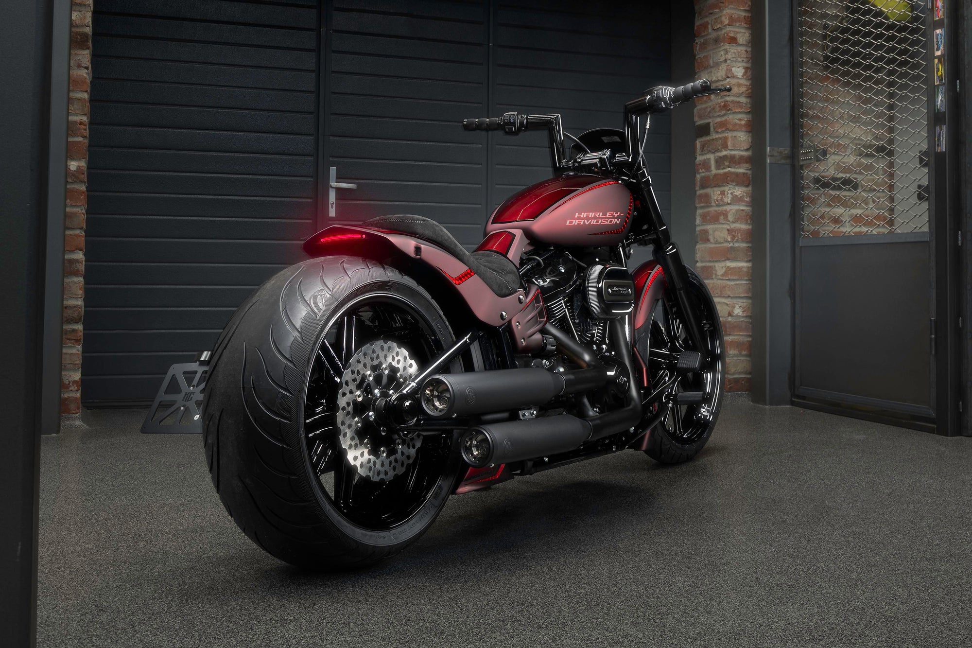  Harley Davidson motorcycle with Killer Custom parts from the rear in a modern garage