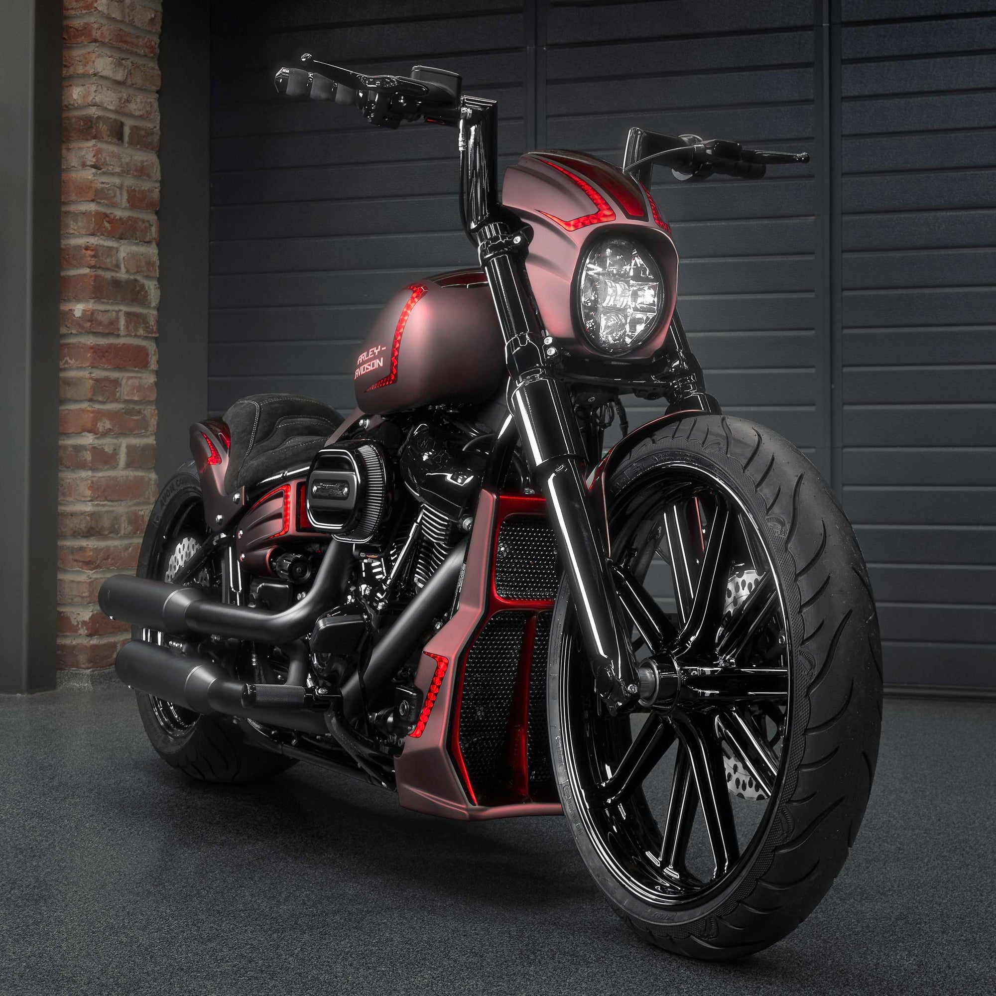 Harley Davidson motorcycle with Killer Custom parts from the front in a modern garage