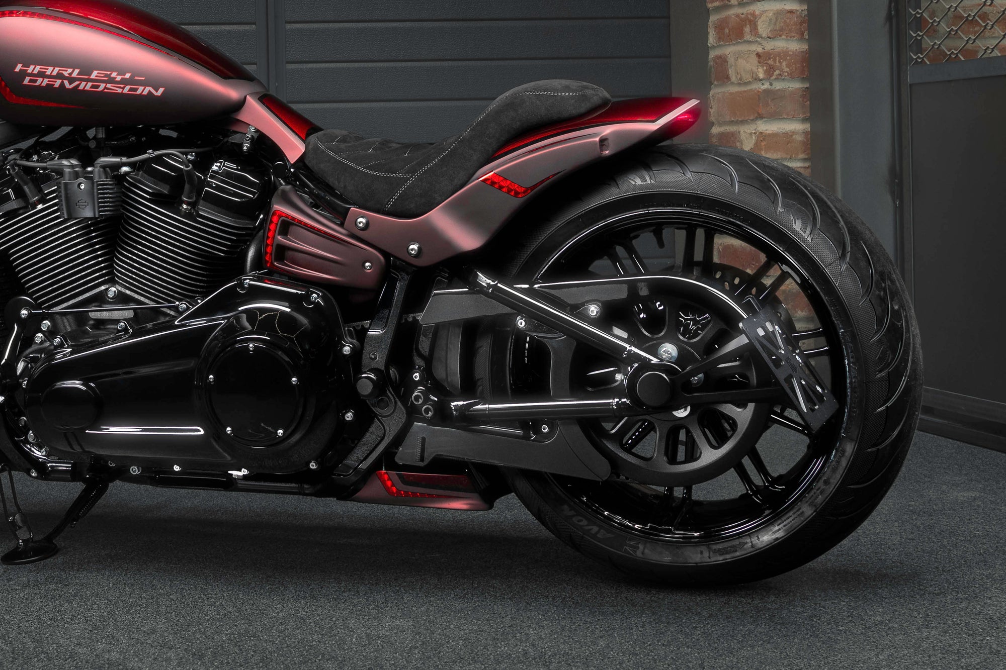 Zoomed Harley Davidson Breakout motorcycle with Killer Custom parts from the side in the garage