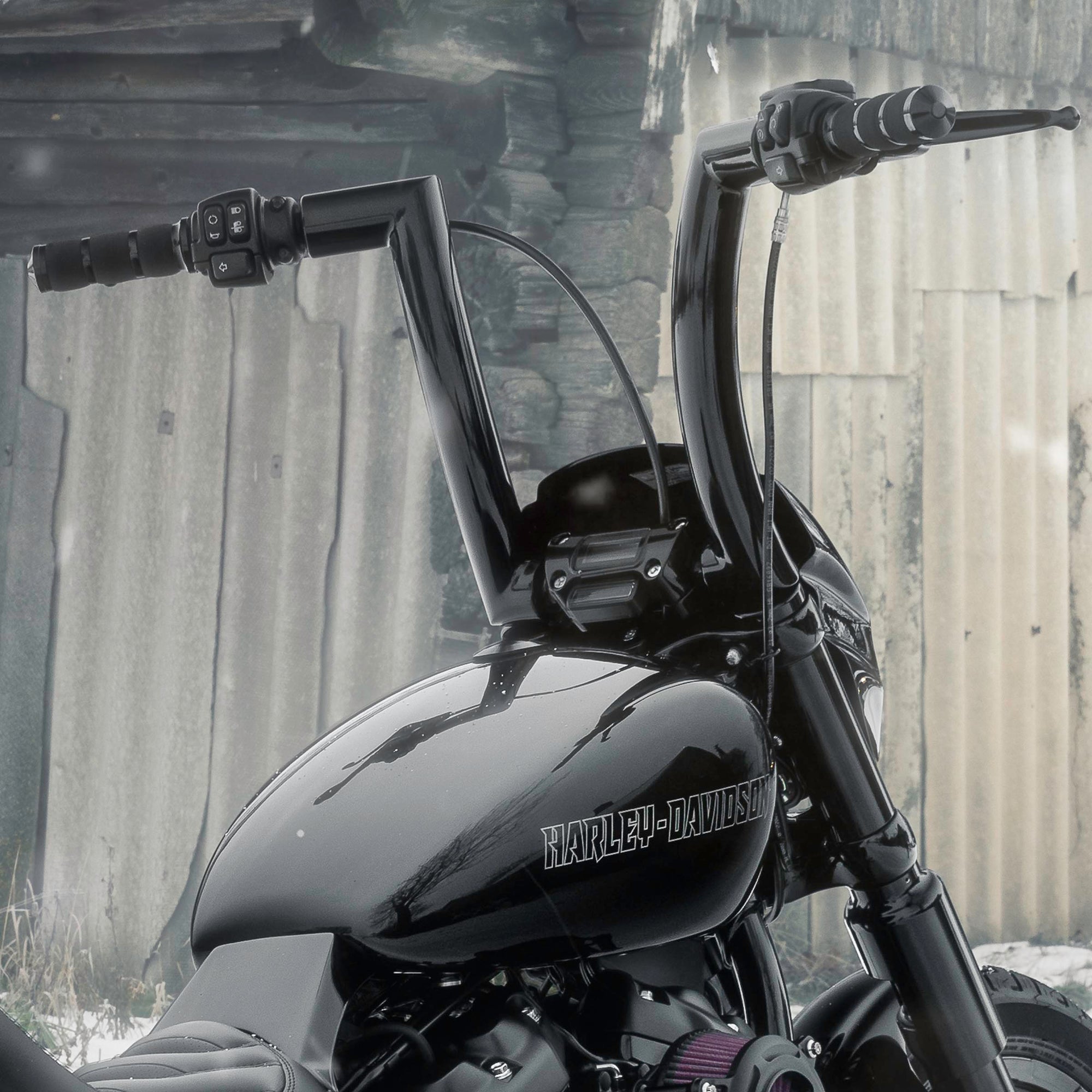 Zoomed Harley Davidson motorcycle with Killer Custom parts outside on a snowy day in an abandoned environment