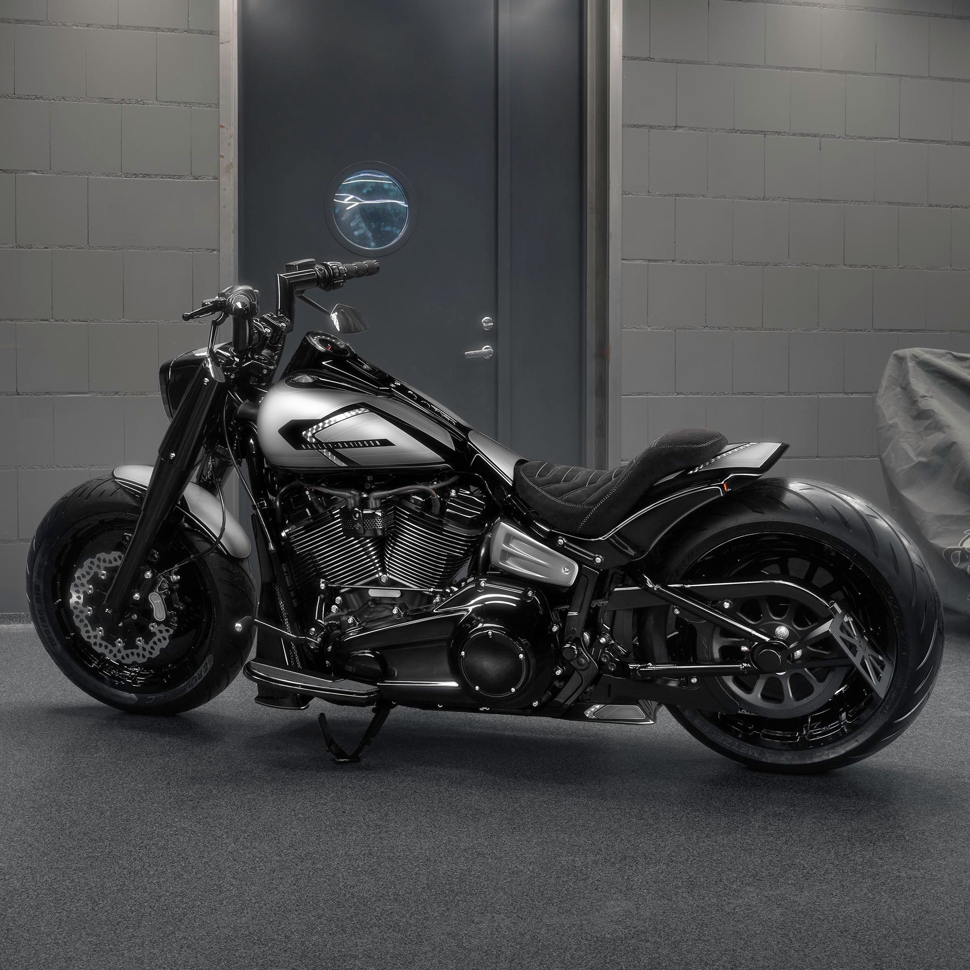 Harley Davidson motorcycle with Killer Custom parts from the side in a modern bike shop