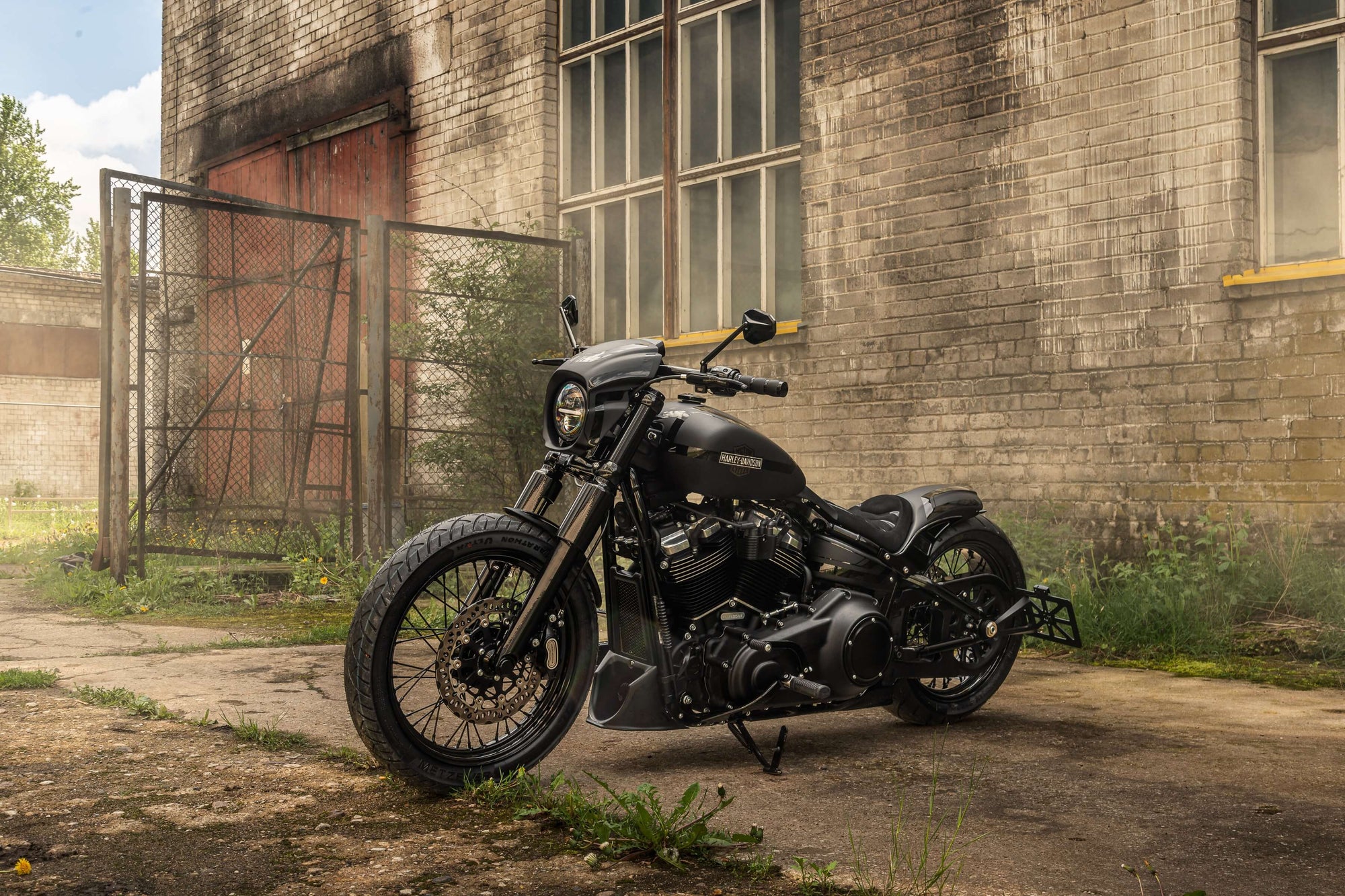 Harley Davidson motorcycle with Killer Custom parts from the side in an abandoned environment