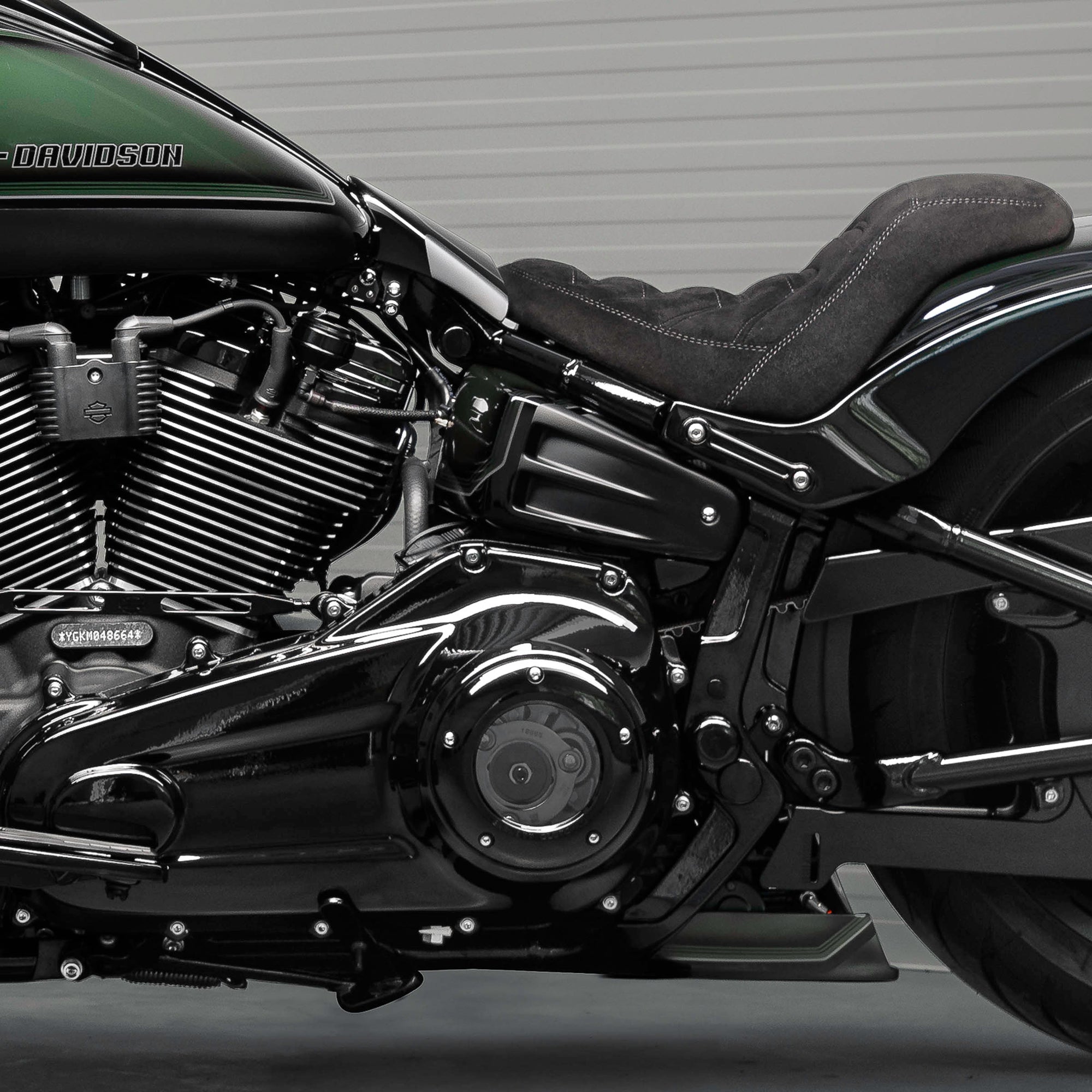 Zoomed Harley Davidson motorcycle with Killer Custom parts from the side neutral background