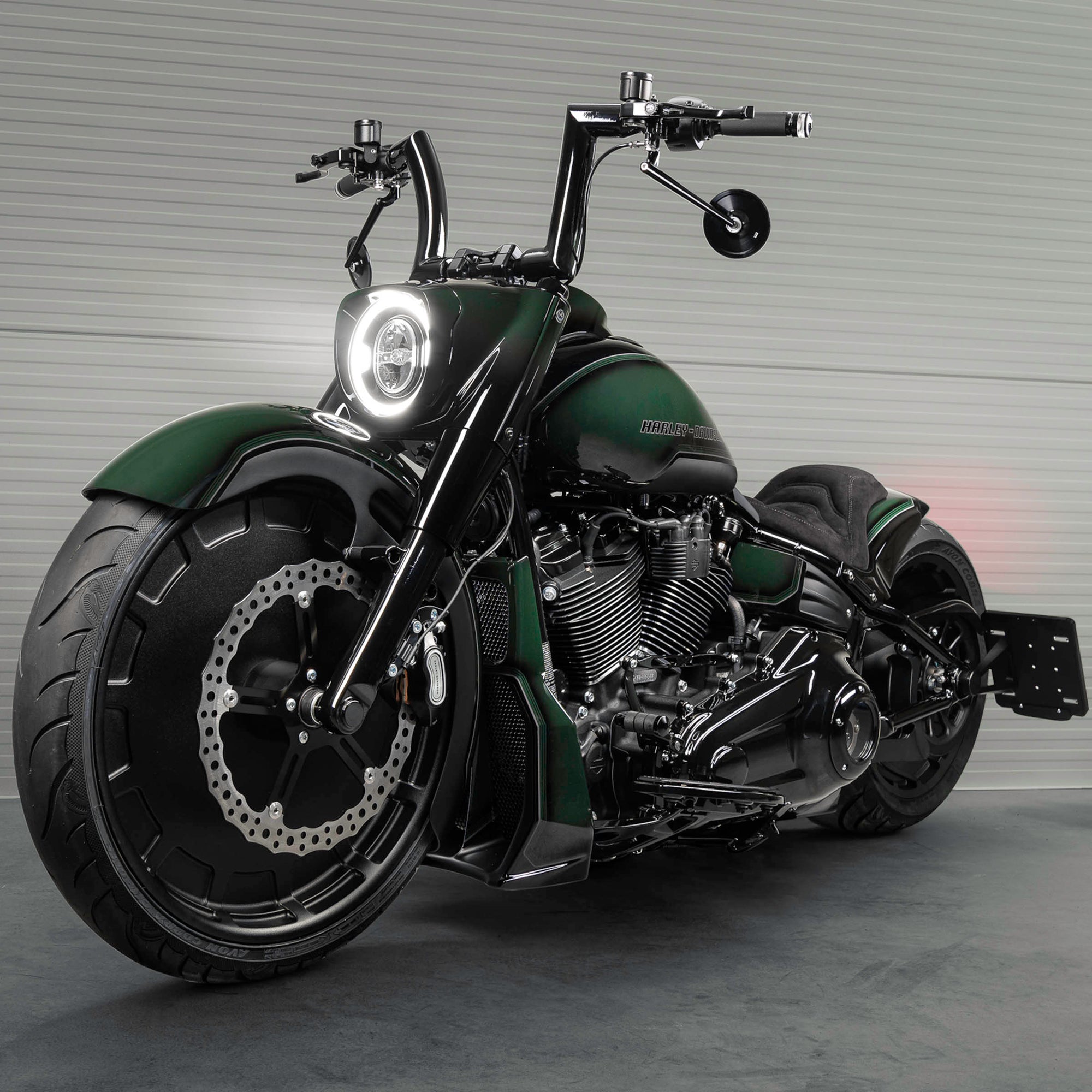 Harley Davidson motorcycle with Killer Custom parts from the front in a spacious and modern garage