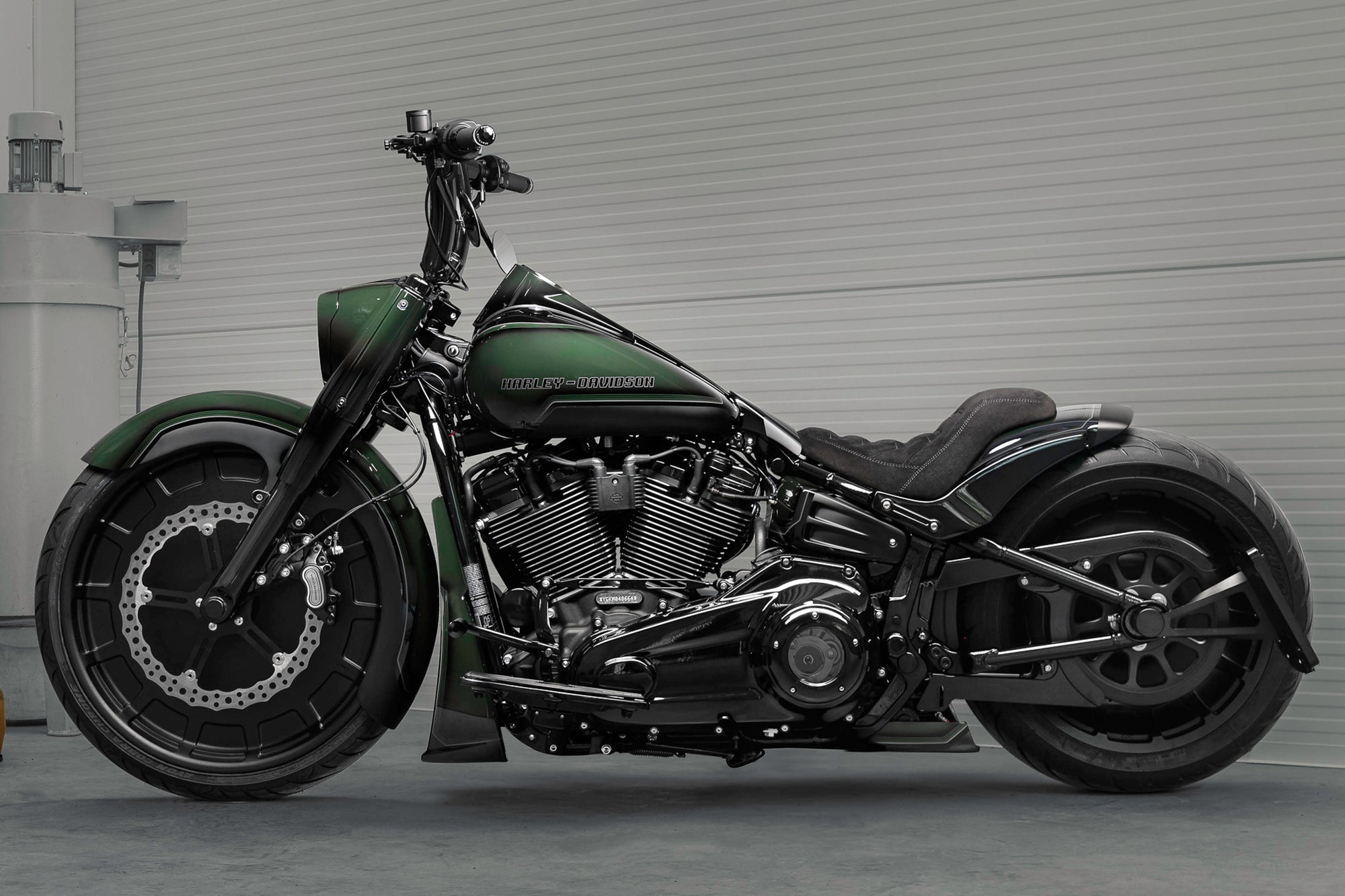 Harley Davidson motorcycle with Killer Custom parts from the side in a spacious and modern garage