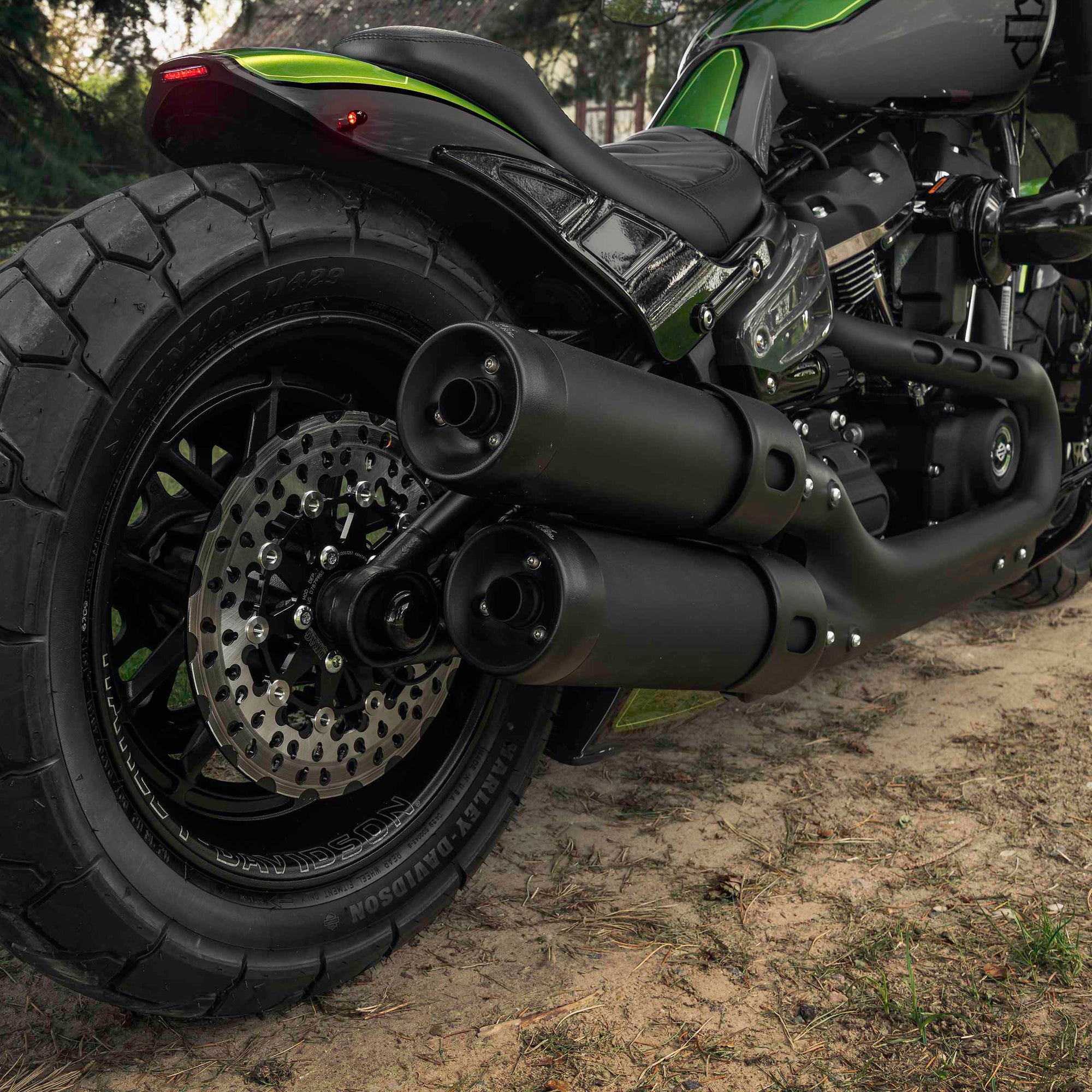 Zoomed Harley Davidson motorcycle with Killer Custom parts from the rear in a nature environment