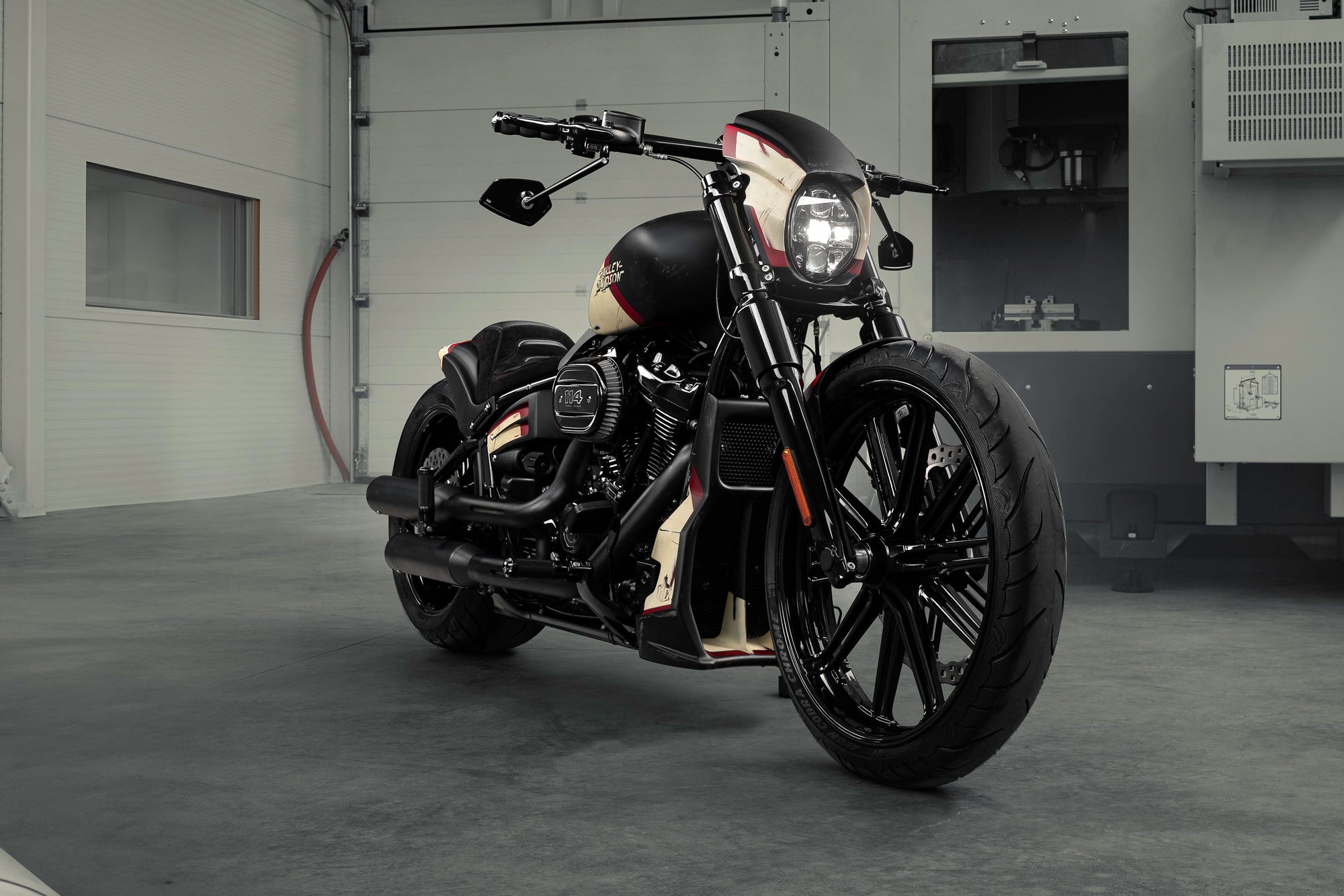 Modified Harley Davidson Breakout motorcycle with Killer Custom parts from the front in a modern bike shop