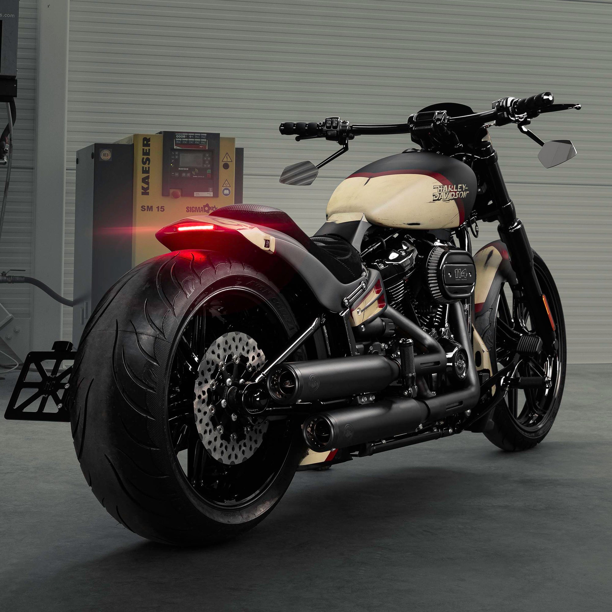 Harley Davidson motorcycle with Killer Custom parts from the rear in a modern bike shop