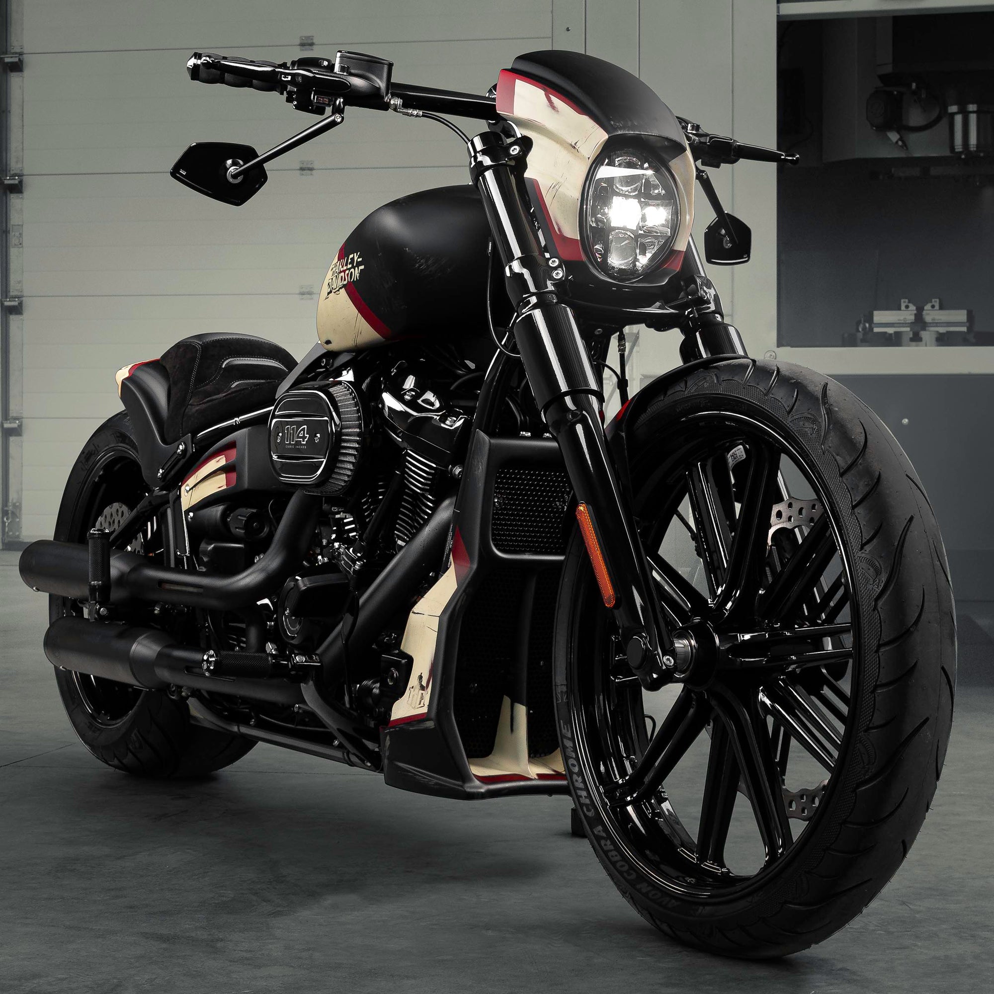 Modified Harley Davidson Breakout motorcycle with Killer Custom parts from the front in a modern bike shop