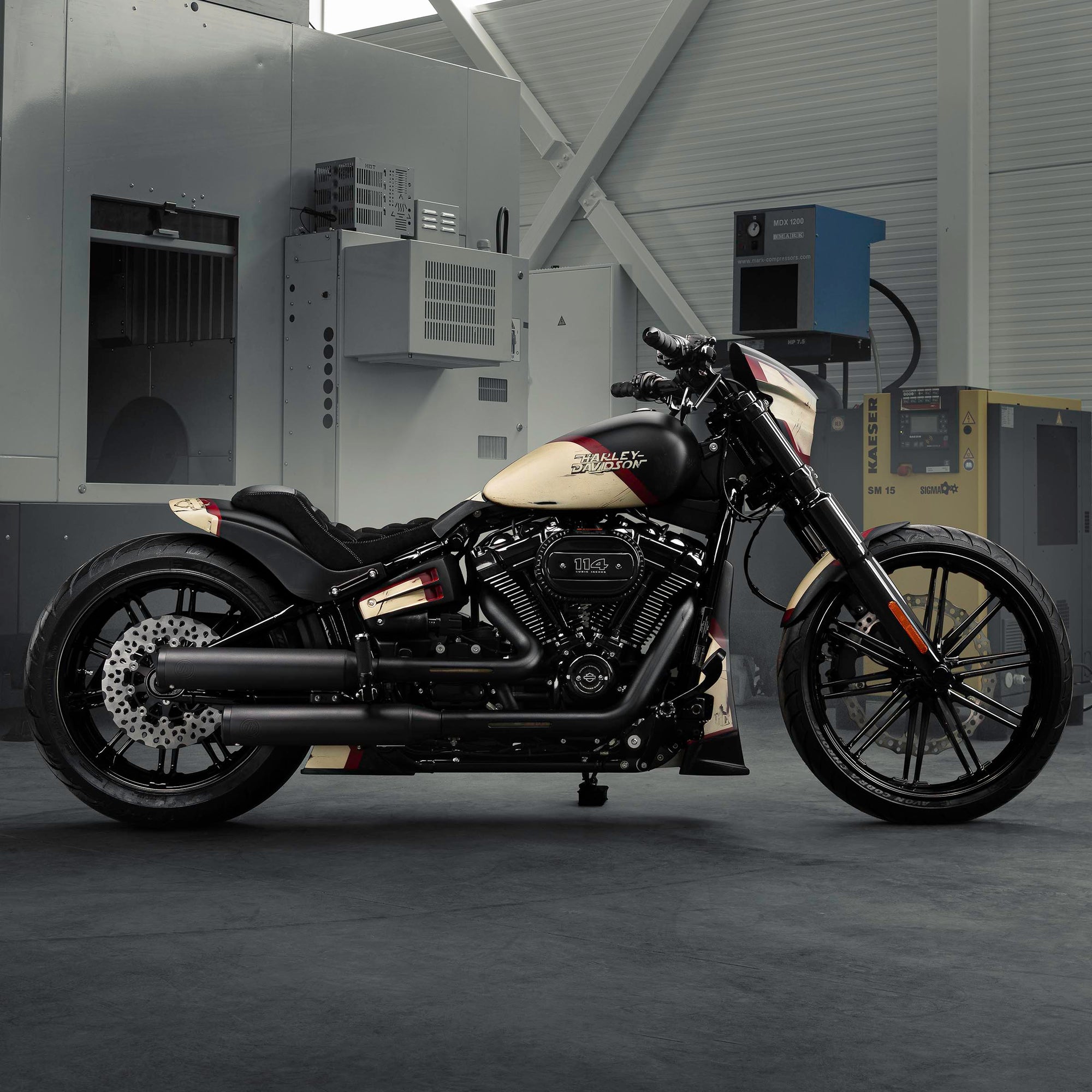 Modified Harley Davidson Breakout motorcycle with Killer Custom parts from the side in a modern bike shop