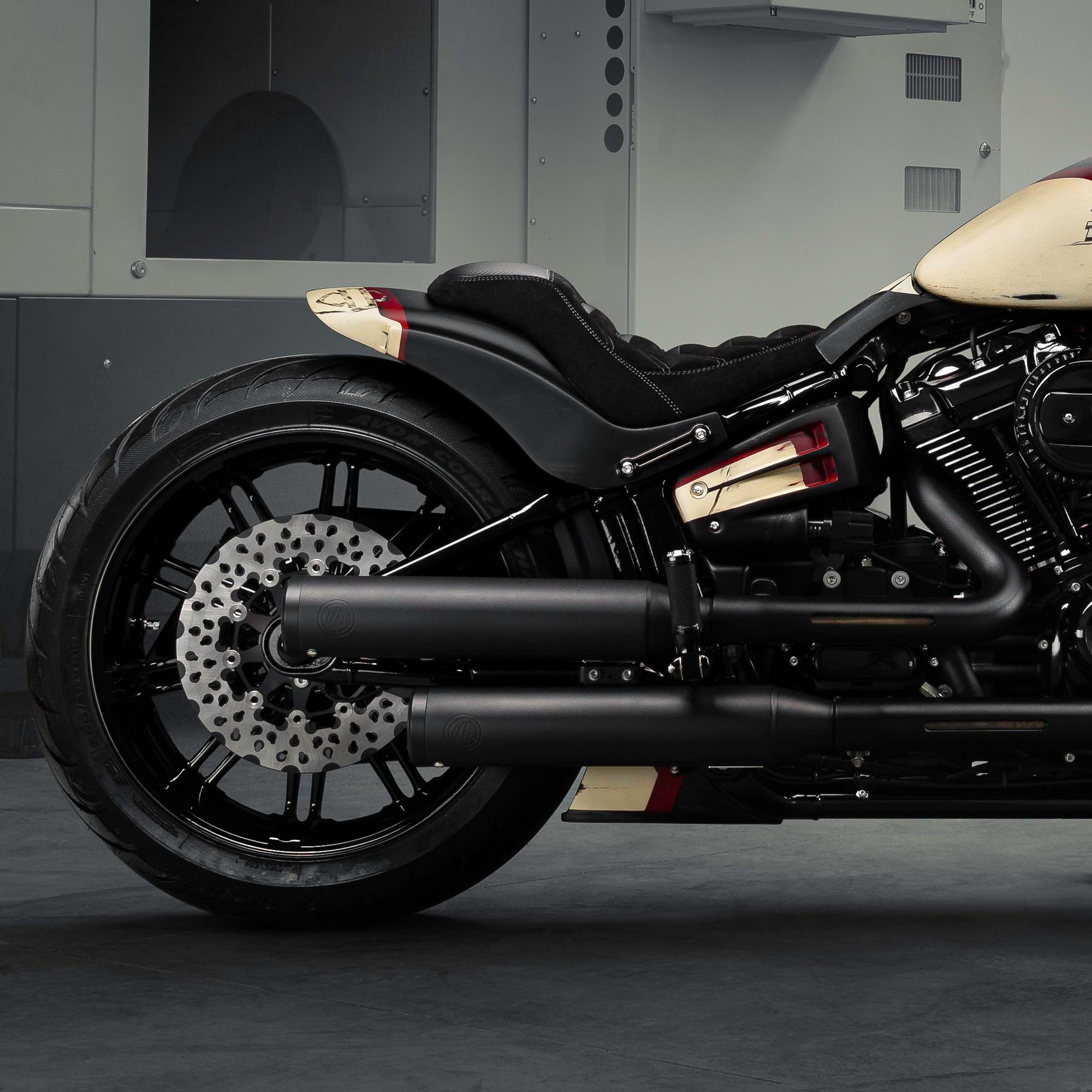 Zoomed Harley Davidson motorcycle with Killer Custom parts from the side in a modern bike shop
