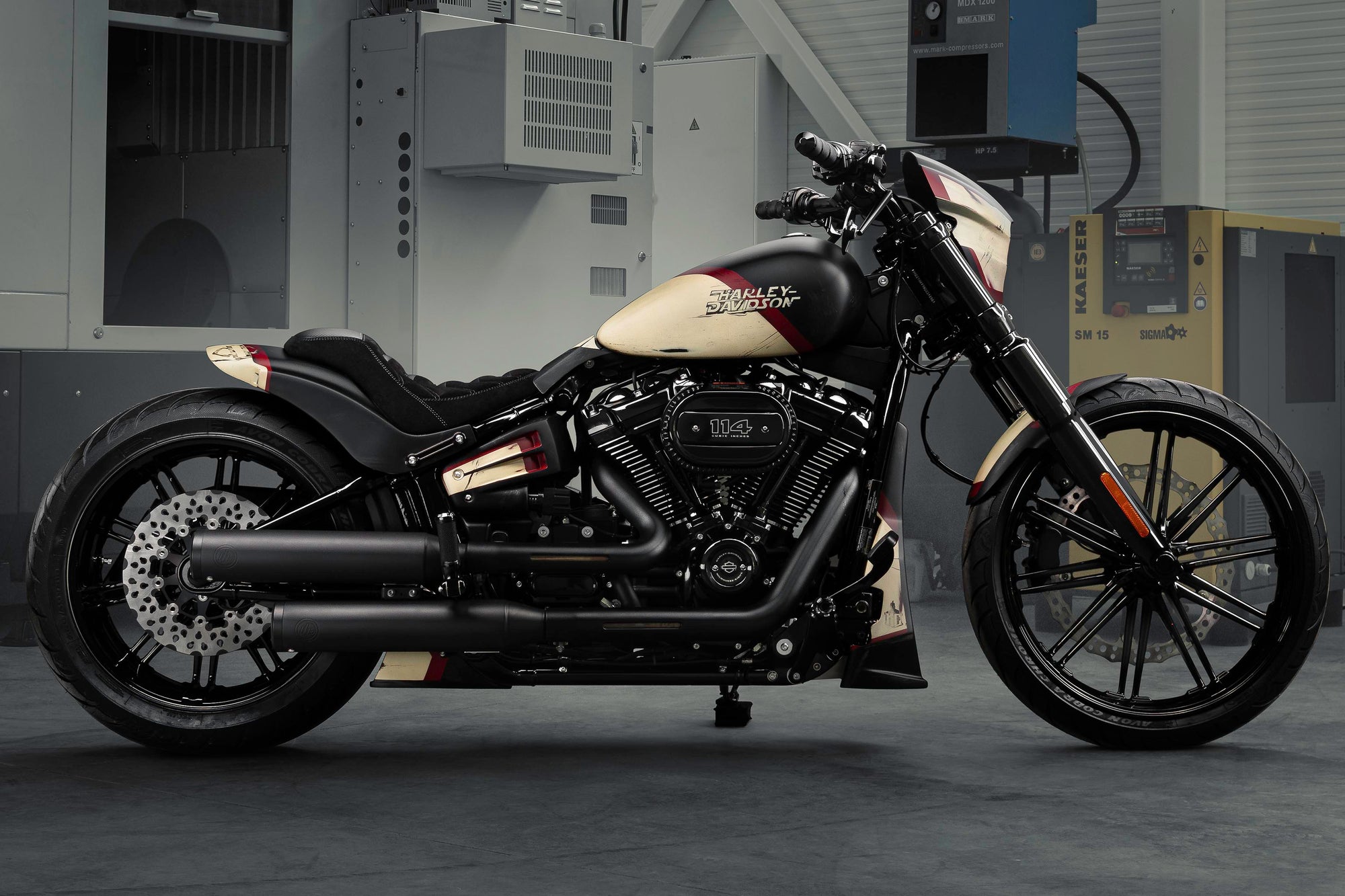 Modified Harley Davidson Breakout motorcycle with Killer Custom parts from the side in a modern bike shop