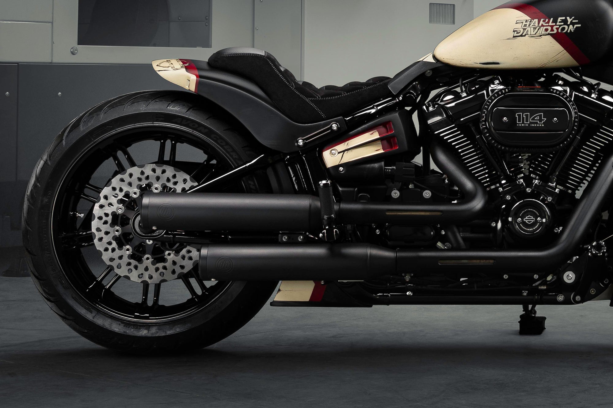 Zoomed Harley Davidson motorcycle with Killer Custom parts from the side in a modern bike shop