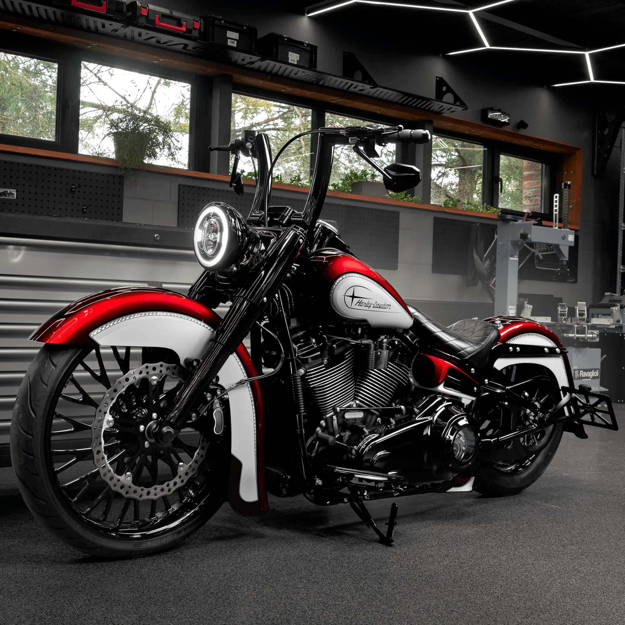 Modified Harley Davidson Heritage motorcycle with Killer Custom parts from the side in a modern bike shop